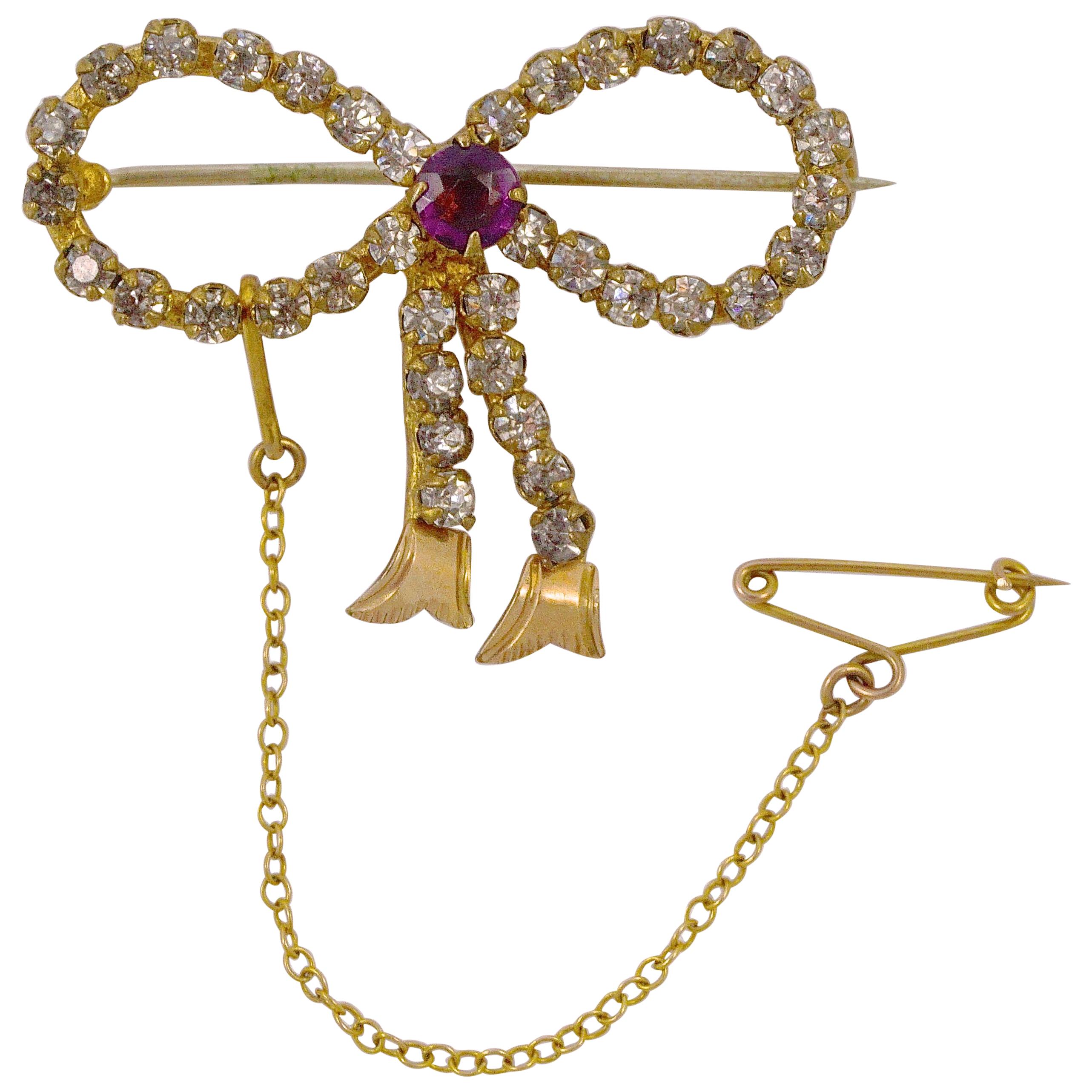 Antique Gold Tone Amethyst and Clear Paste Bow Brooch circa 1910 For Sale