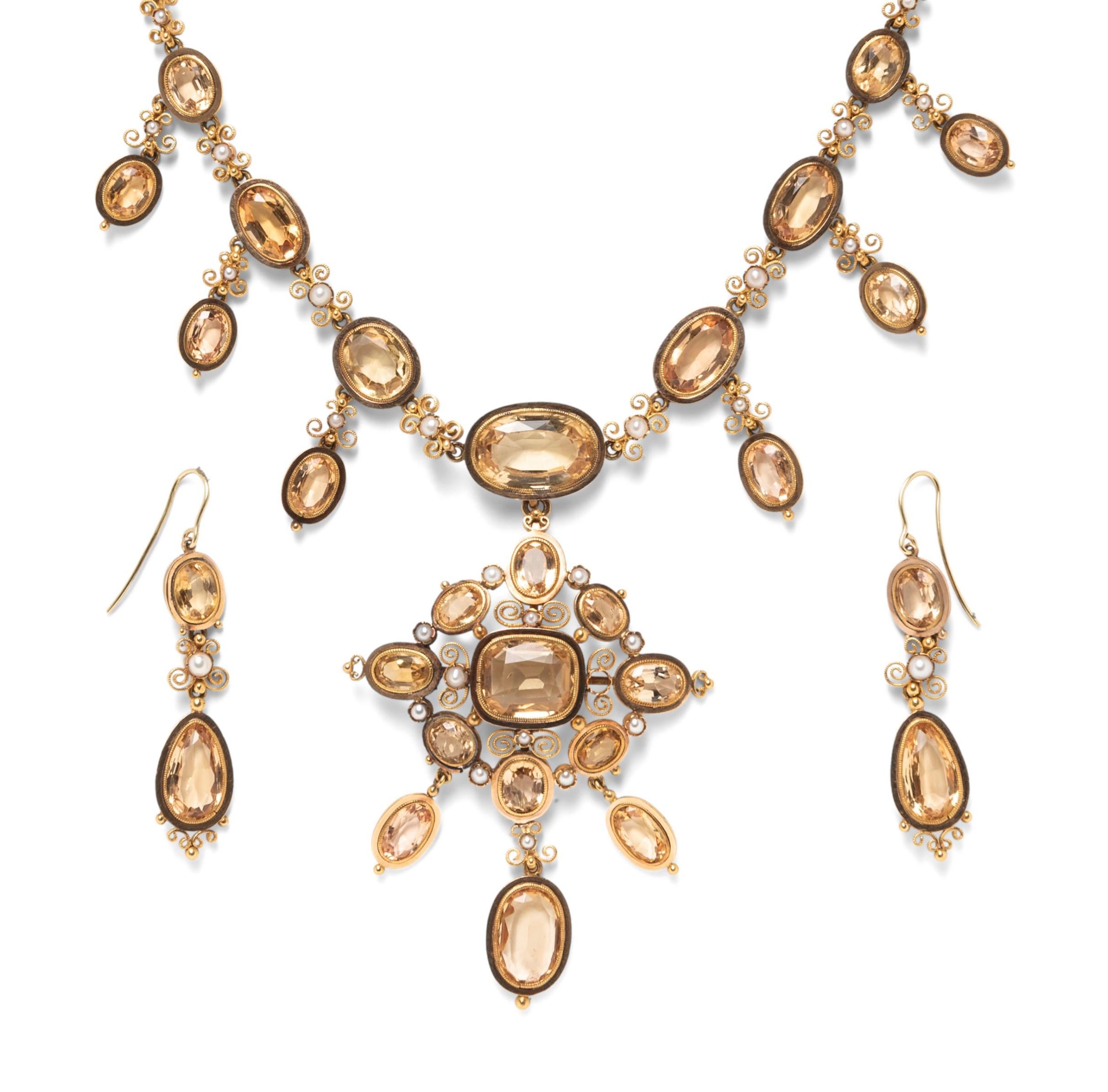 Antique gold and topaz necklace and earrings suite

Necklace with removable pendant and a pair of earrings, bezel-set with cushion and oval cut topaz, with split pearls

Necklace
Size: length 14.5 inches; pendant width 2 inches, length 2.75