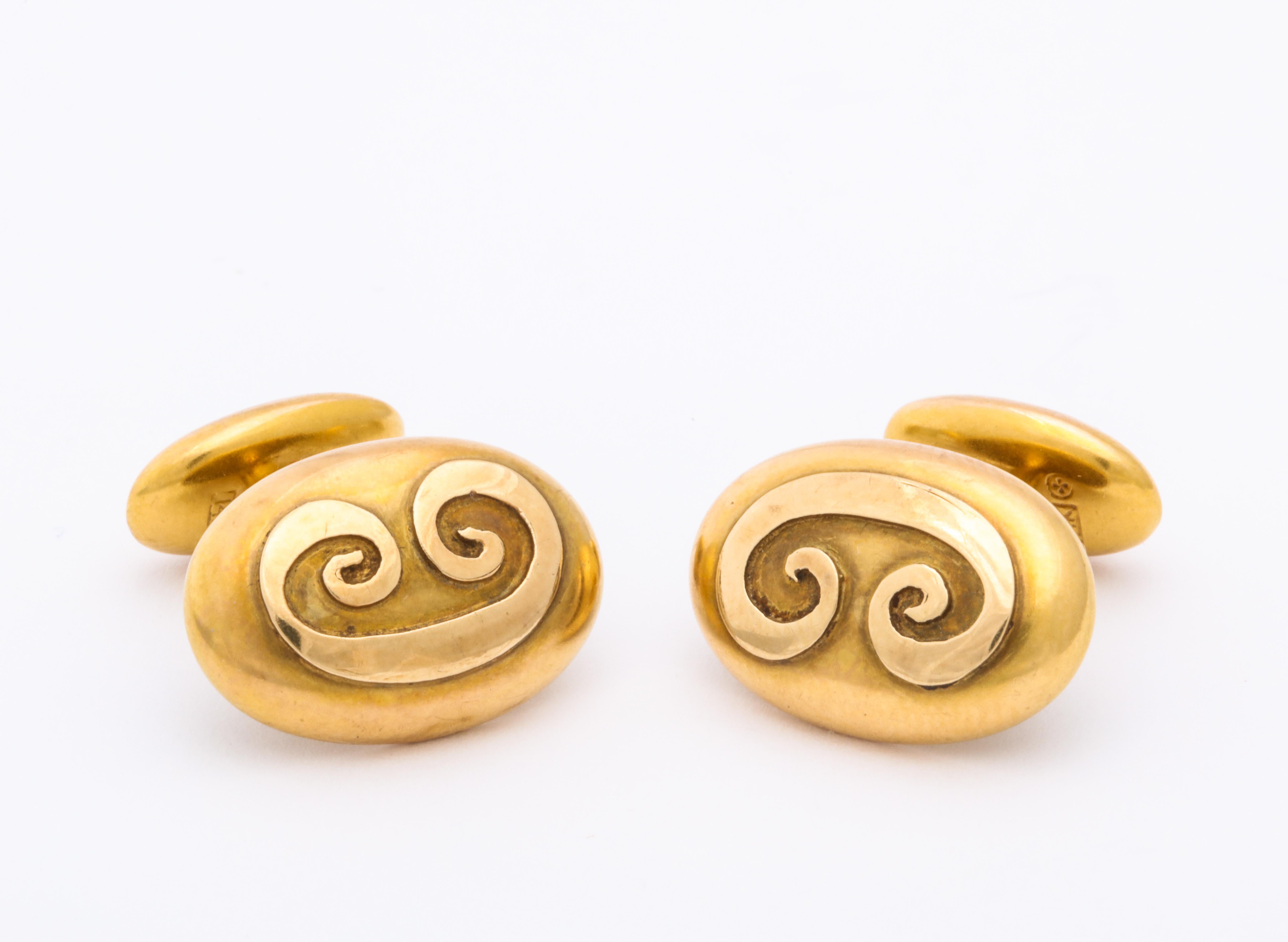 Made in America, one-half inch wide oval links are 14 Kt gold and were made between 1900 and 1915. 
A double sided scroll is engraved in relief on the negative space. The back end is oval and just the right size to easily insert into a cuff.  There