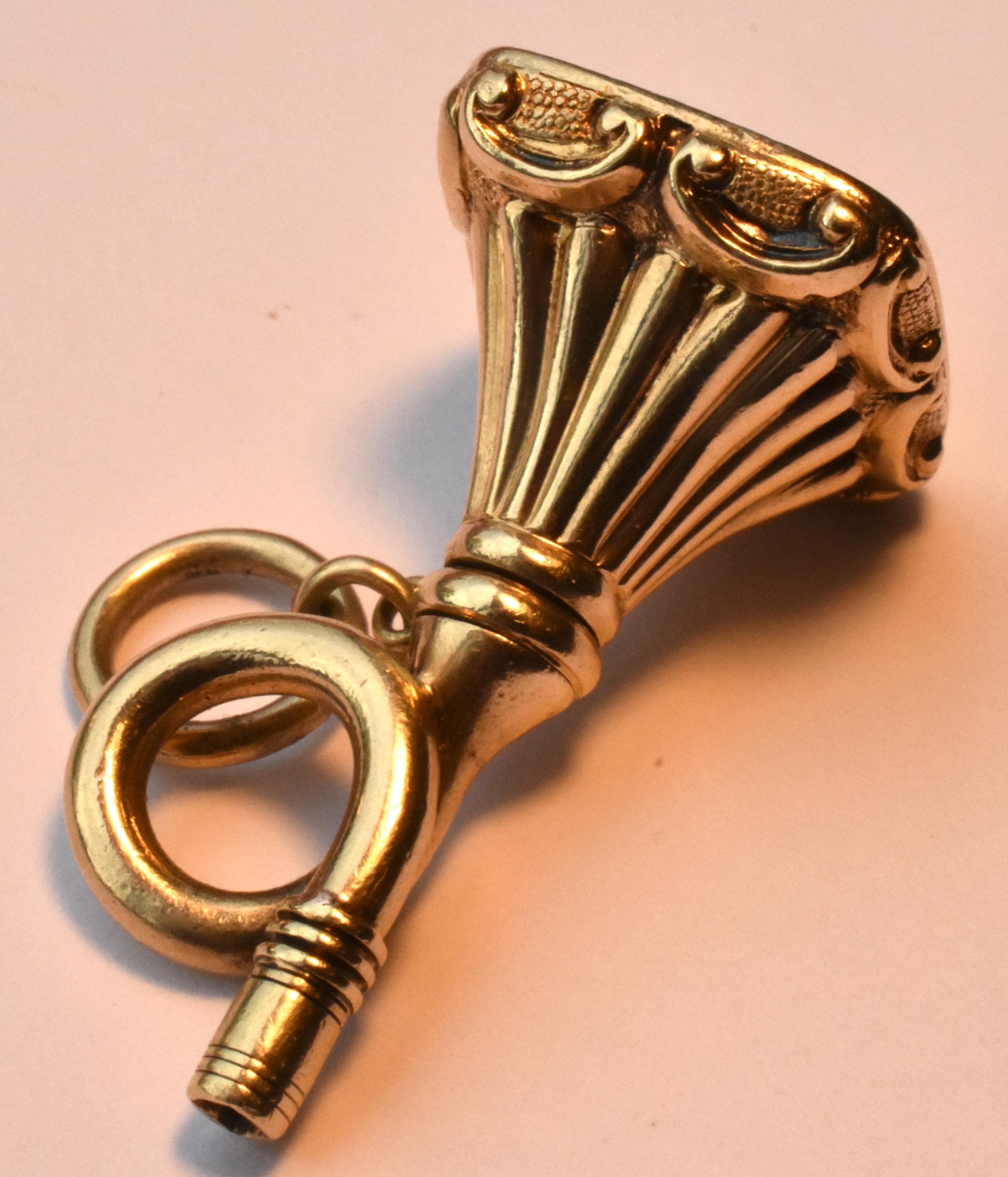 Unusual Antique 18K gold Victorian Combination Watch Key & Fob Seal in the form of a trumpet, c1880.  A dragon intaglio is carved on the bloodstone seal.  The size is 1 1/4