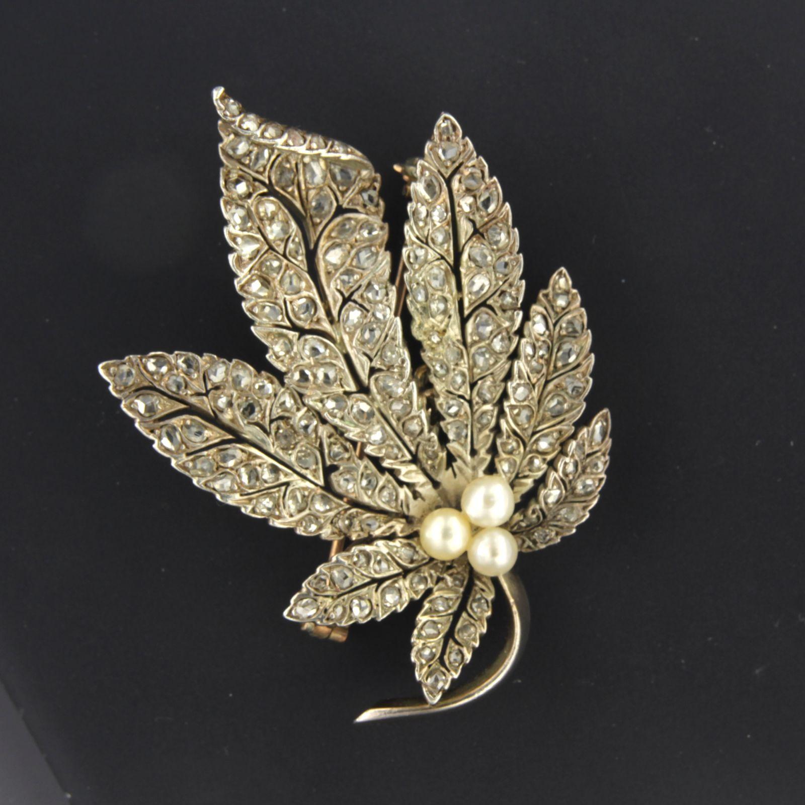 Antique 14kt golden leave broche with rose cut diamonds 1.00 carat H-I color SI-P clarity, set on 835 silver.

The leaves are full set with numerous rose cute diamonds, and in middle are three small pearls.

Weight 19.9 grams
Dimensions : 6.0 cm x