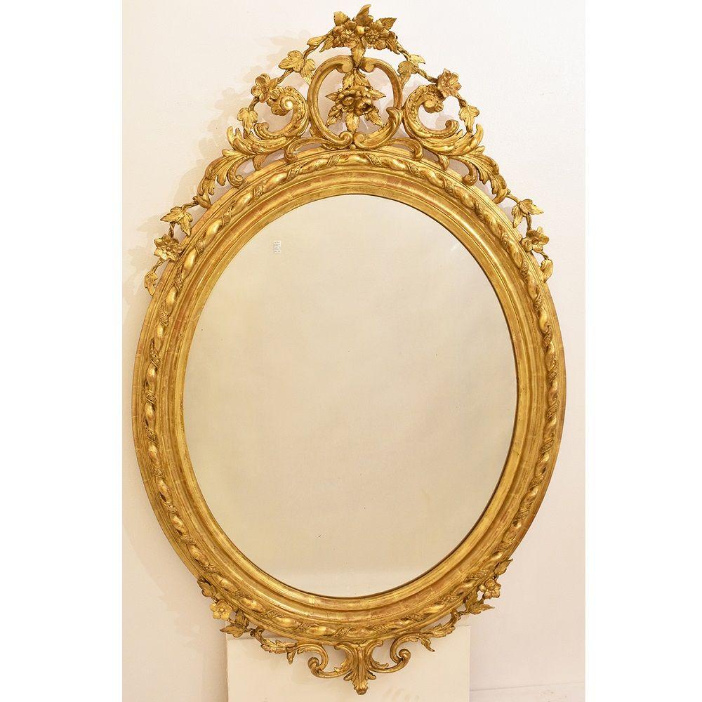 The large round mirror, antique oval mirror proposed here has a Golden Frame in pure gold leaf. 

This antique round wall mirror was realised in the 19th Century, XIX. Louis Philippe.

We can note that the mirror and the back are authentic and