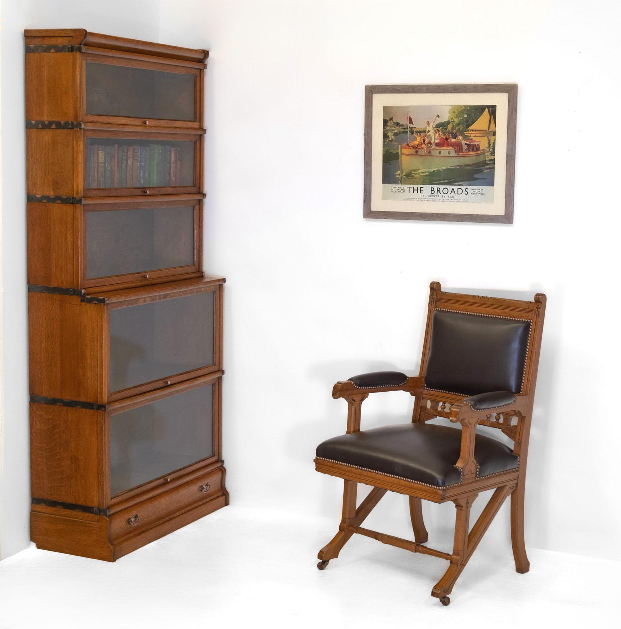 An antique Edwardian solid golden quartersawn oak five sectional bookcase, with copperised strapped sides and drawer below. Made by Globe Wernicke - England. Labelled. Circa 1900.

Delivery is INCLUDED in the price for all areas in MAINLAND England