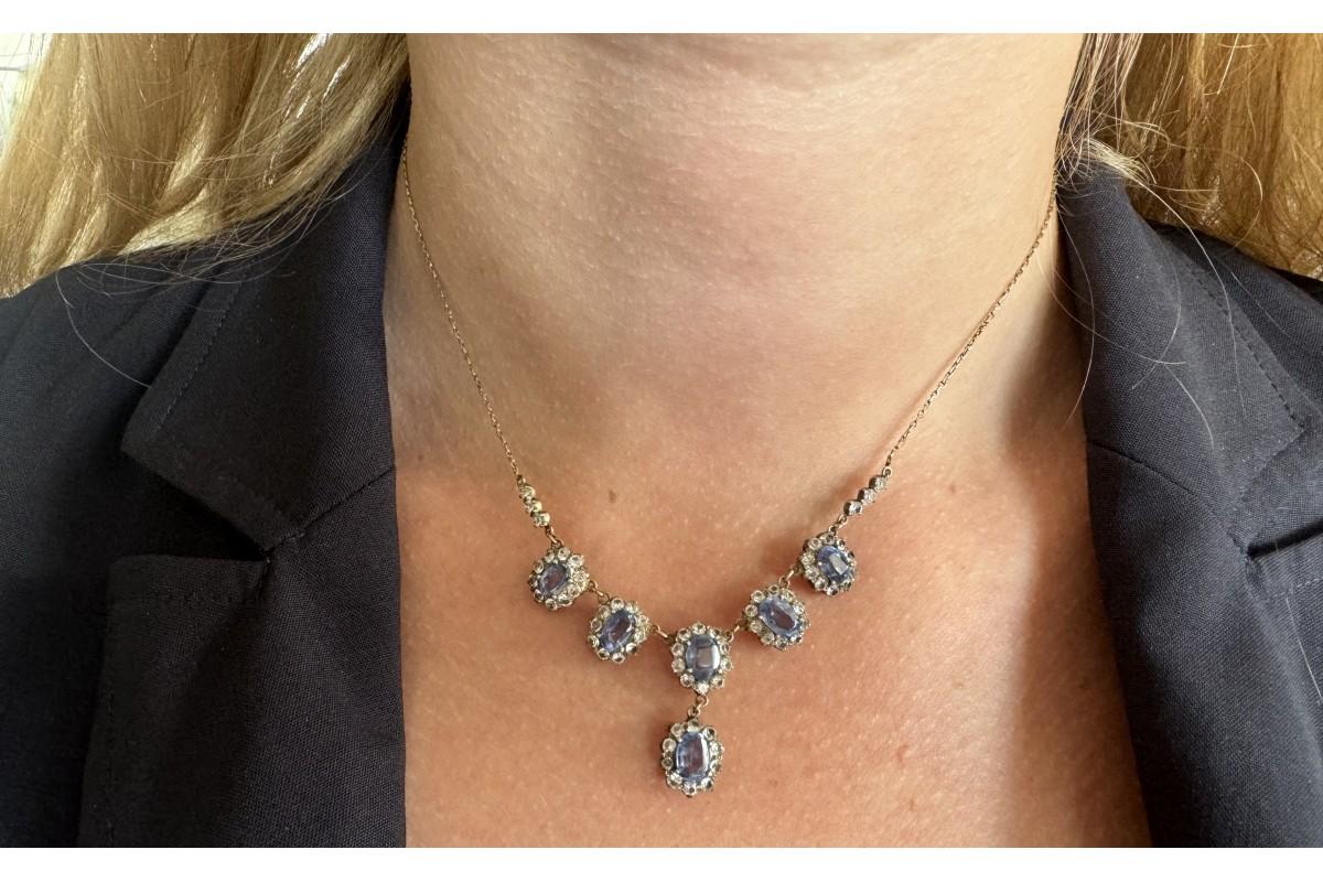A unique set of jewelry, consisting of a necklace and earrings, made of 9-carat gold and 0.950 silver elements. The set is decorated with white and light blue sapphires, The original form of the set dates back to the end of the 19th century, which