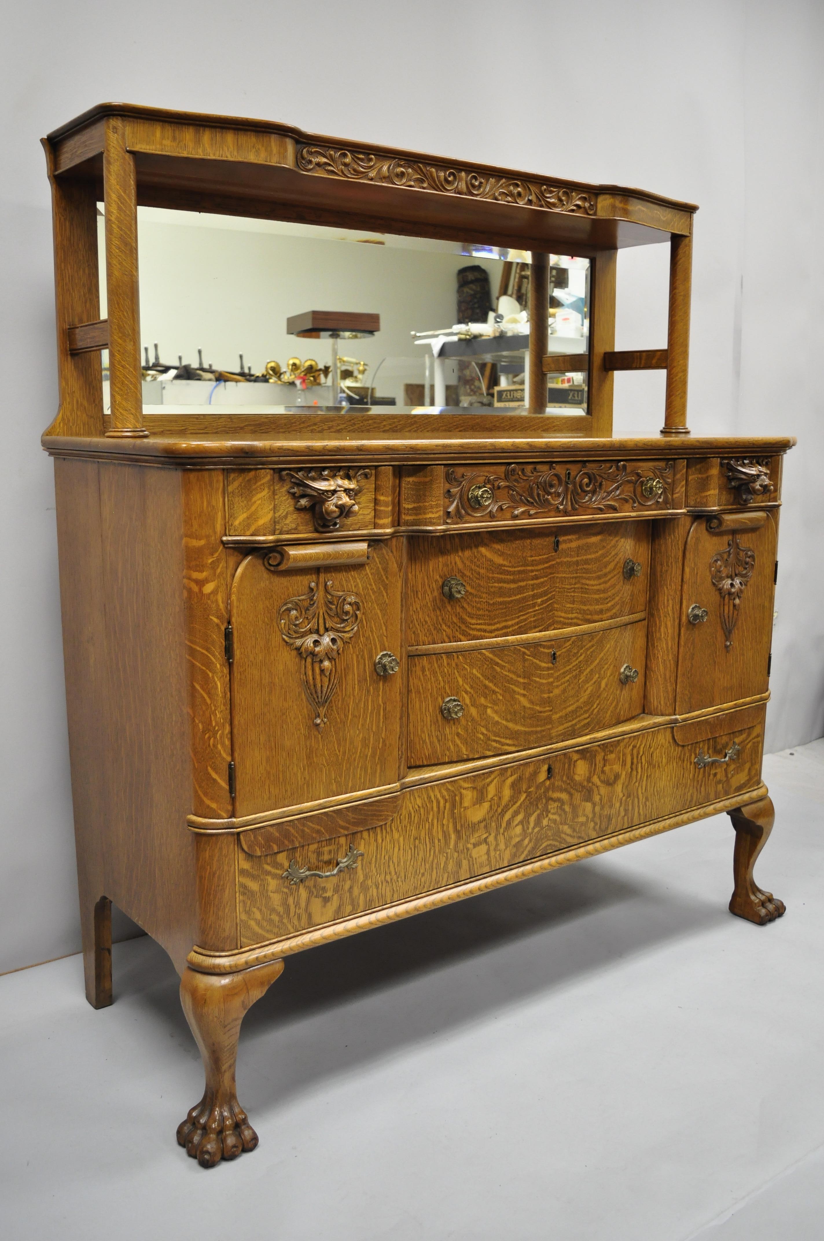 Antique golden tiger oak Victorian paw foot sideboard buffet lions & mirror back. Item features carved paw feet, lion carved pulls, beautiful tiger oakwood grain, 2 swing doors, beveled glass mirror, 6 drawers, very nice antique item, late 19th