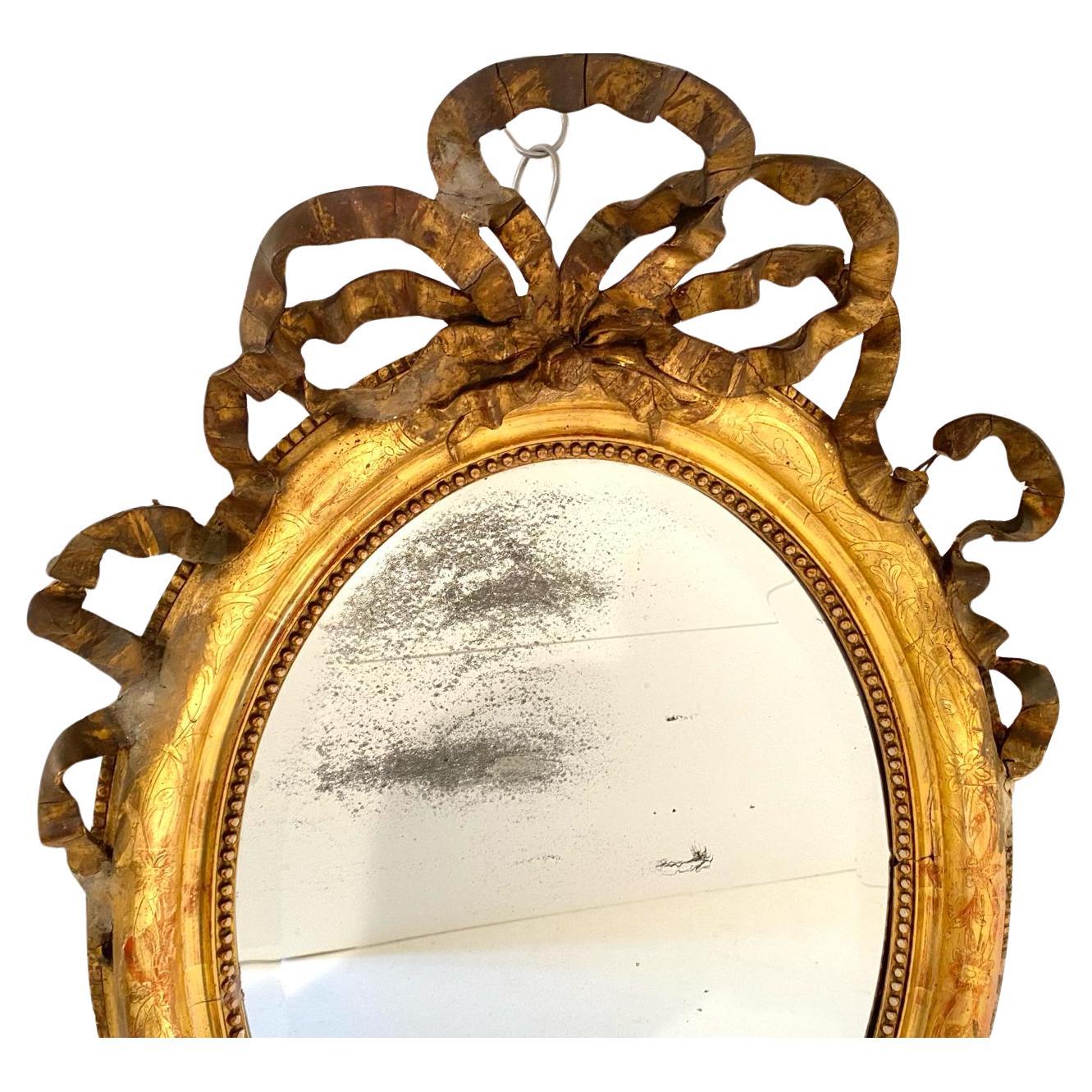 Antique gold Mirror, Italy 1850s.
A rare 19th century gold leaf oval mirror with classy refined frame. 
The mirror is made of a solid wood frame with gold leaf finishing and finely refined with elegant details. Both on the top and the bottom of the