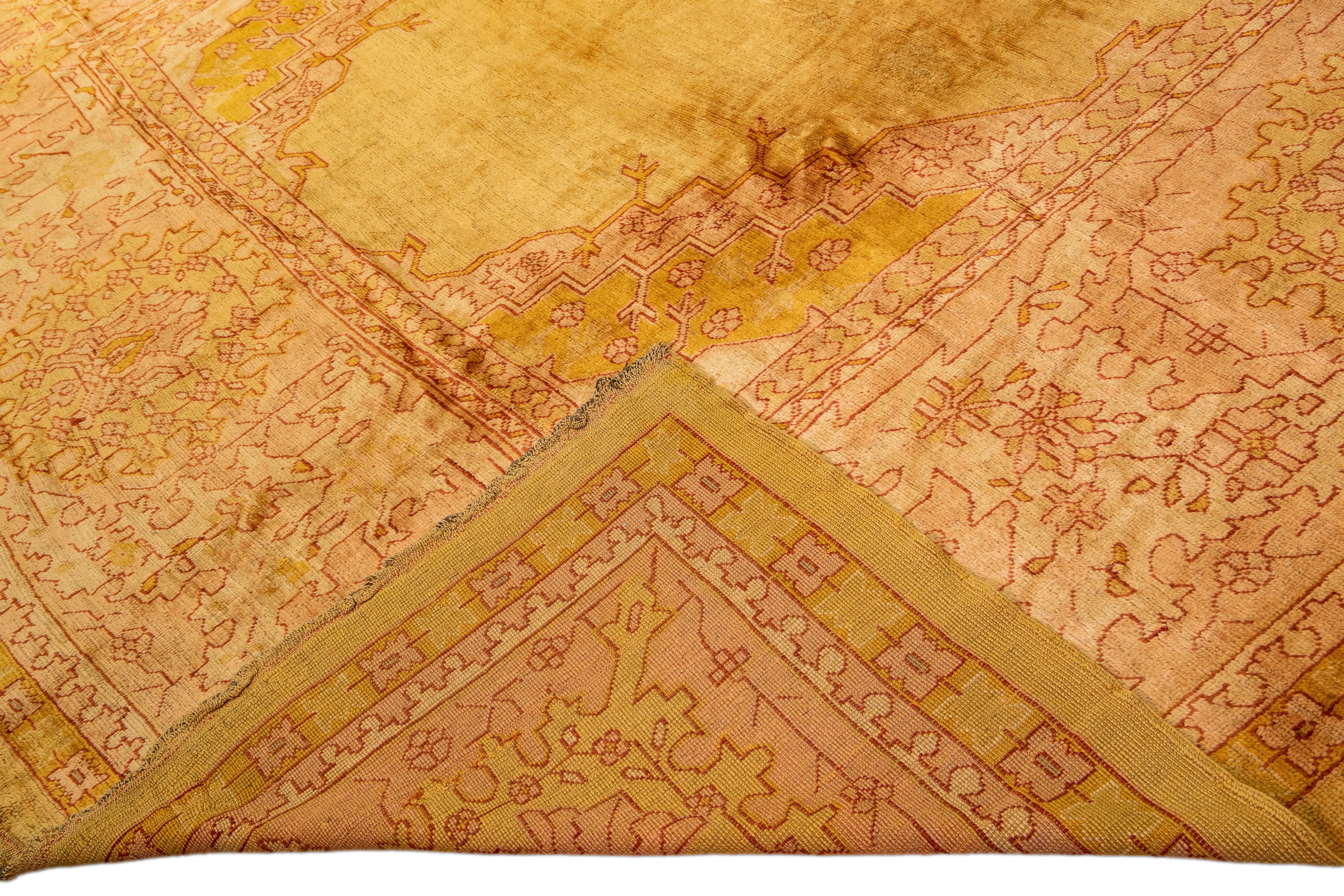Beautiful Vintage Turkish hand-knotted wool rug with a goldenrod field. This rug has a peach floral-designed frame a gorgeous solid field.

This rug measures: 12' x 21'.