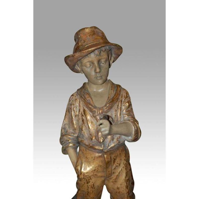 Fabulous antique Goldscheider figure of bare footed boy {signed J Mercadier } . 24 ins tall 

In 1885, Friedrich Goldscheider came from the small Bohemian city of Pilsen to Vienna and founded the Goldscheider Manufactory and Majolica Factory. It