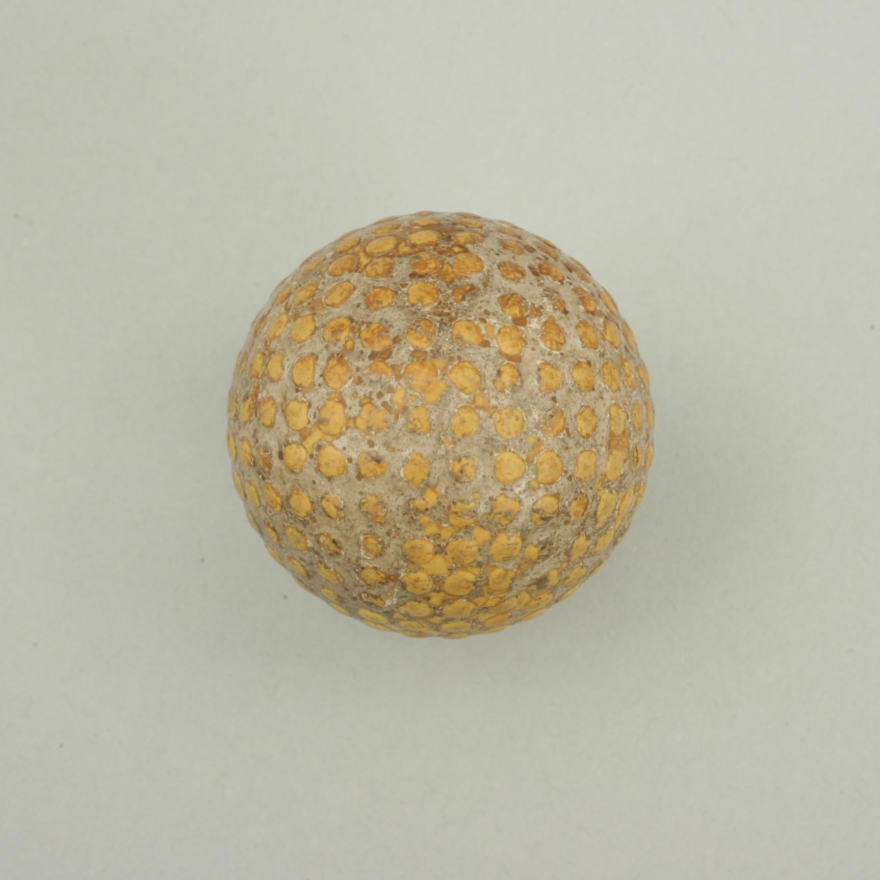 Bramble golf ball.
A bramble patterned rubber core golf ball. The ball is with out name and no makers details, circa 1900's. The ball pattern is made up of raised dimples, there is a crack in its surface.
The ball is approximately 1 5/8 inch in