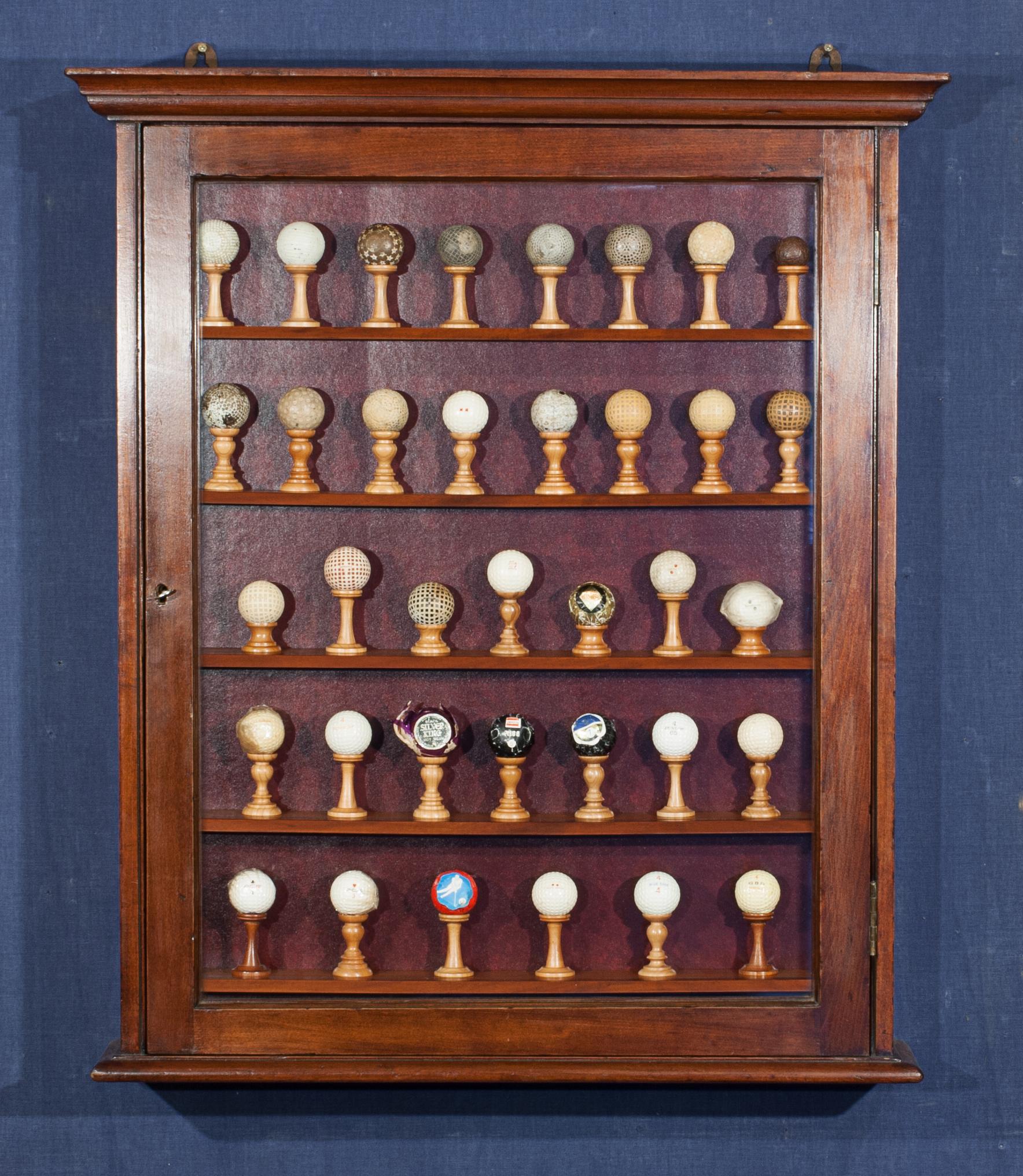 Golf ball display in cabinet.
A wonderful collection of antique golf balls in a wall display cabinet with a single glazed door, with lock and key. The glass door gives a clear view of the interior, whilst helping to protect the items displayed from