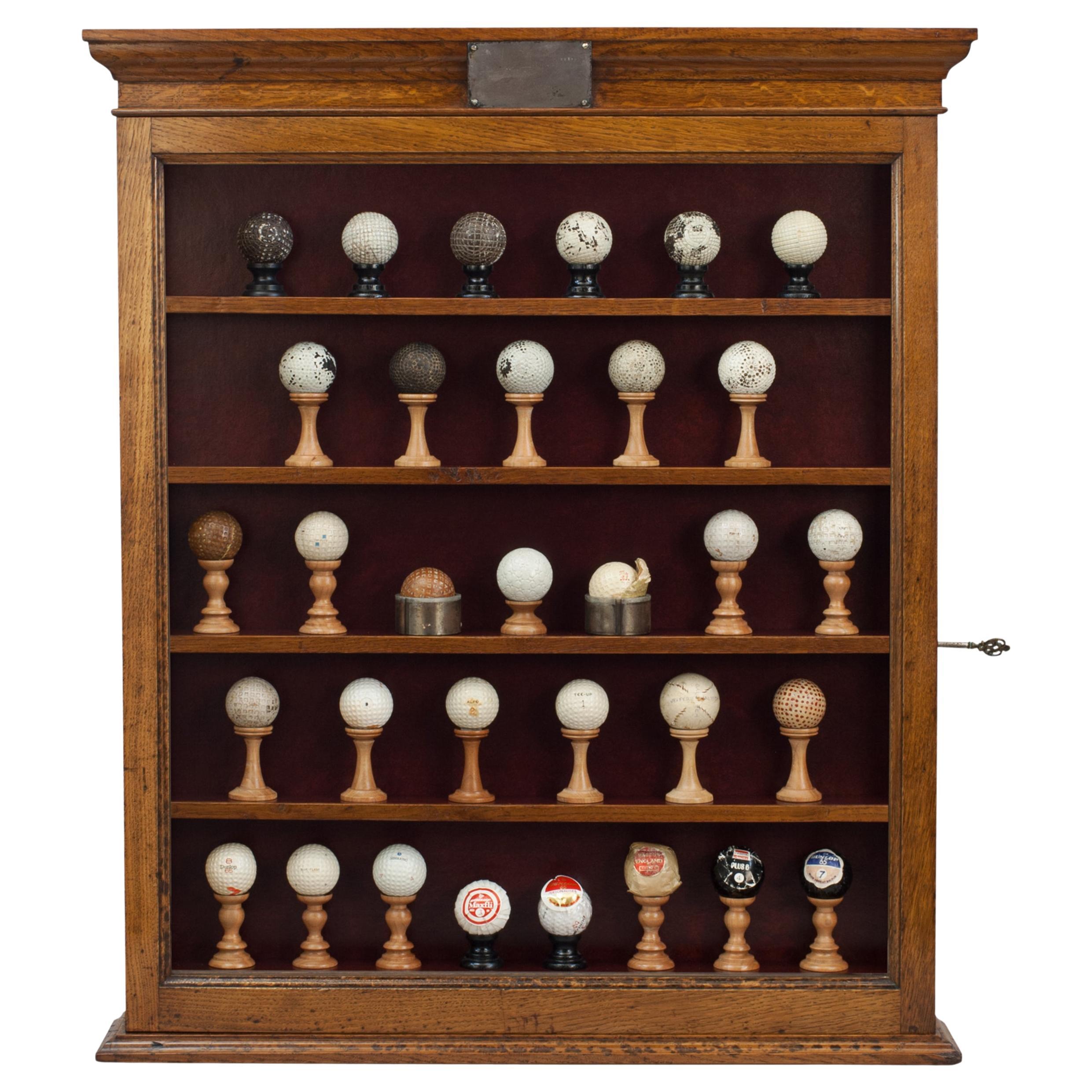 Antique Golf Balls In Display Cabinet