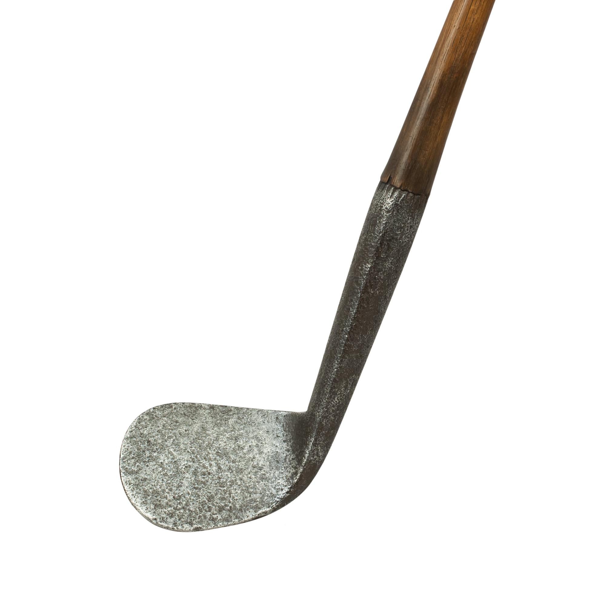 Robert white hickory shafted rut iron.
A good quality smooth faced rut or track iron golf club with hickory shaft with sheep skin grip. The head stamped on the back 'R. White, Maker, St Andrews'. A nice desirable golf collectable. The club head has