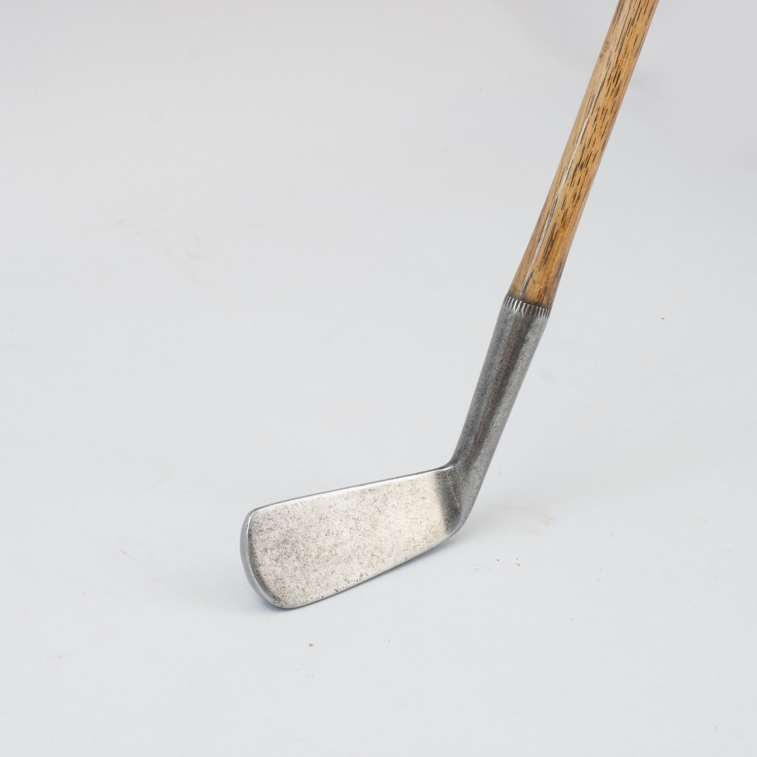 James Braid Mussel Back Approaching Cleek By William Gibson.
Hickory golf club cleek by William Gibson, Fife, endorsed by five times Open Champion, James Braid. The club carries the James Braid endorsement autograph and the 'Out Line Star' cleek