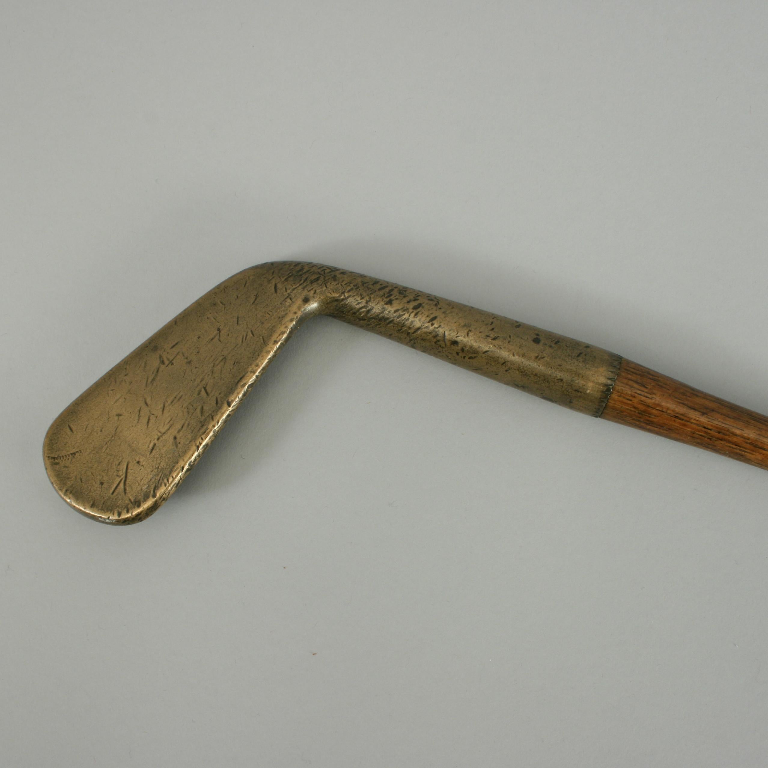 Antique hickory golf club iron, bronze head.
A good bronze (gun metal) head golf club, known as a lofting iron. The IDEA of a lofting iron is to elevate the ball on approach shots. The iron is smooth faced with a very slight concave face to it. The