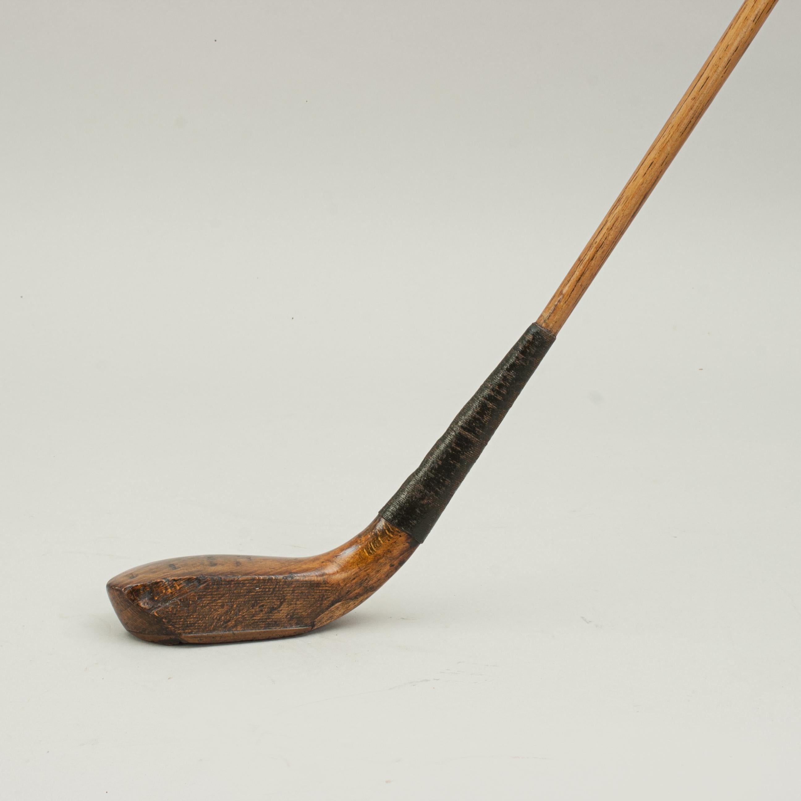 Scared head golf club, driver, by Willie Park.
A well loved long nose golf club, driver, made by Willie Park of Musselburgh. The stained and polished beech-wood head in good condition with lead weight to the rear, traditional horn slip along the