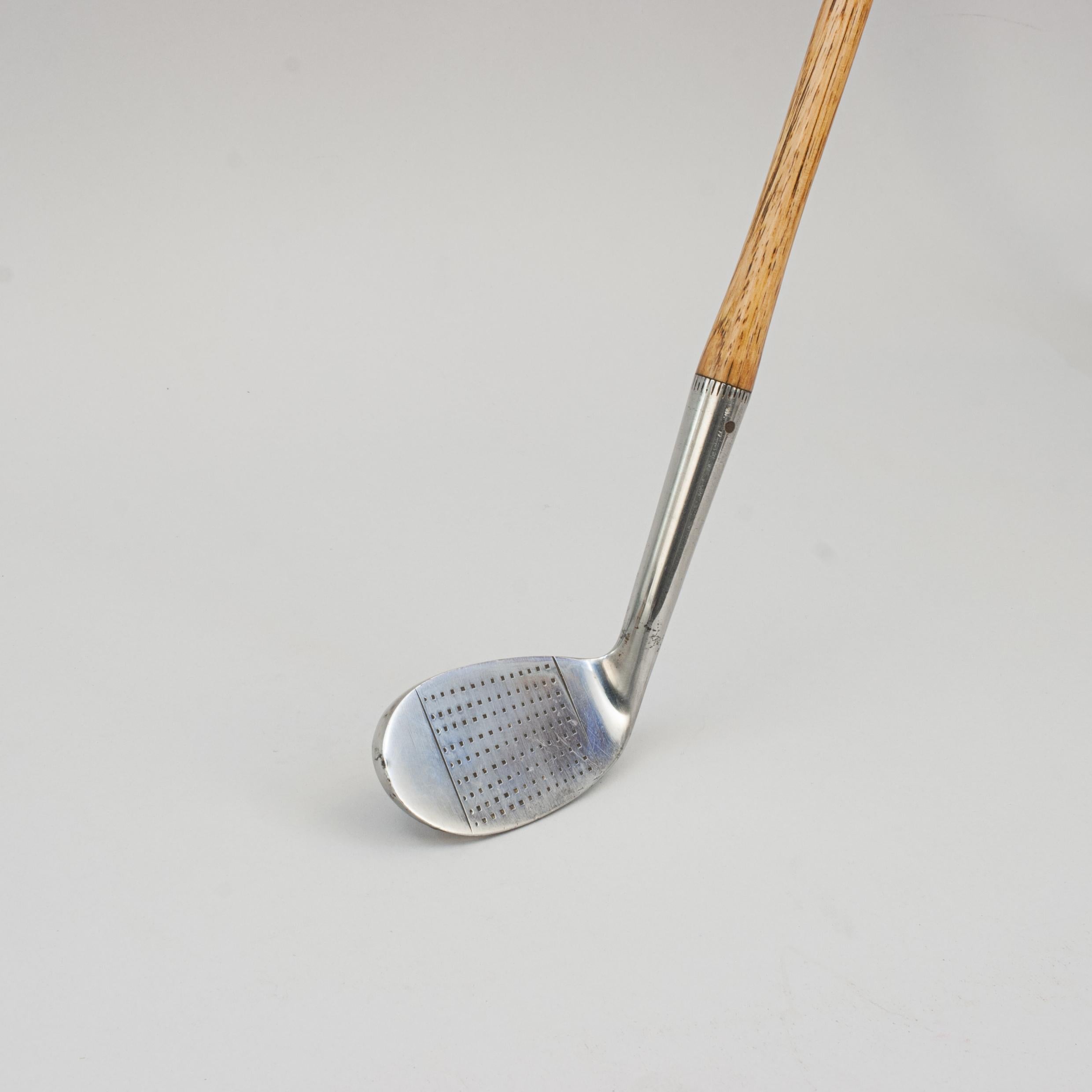 Vintage Hickory Golf Club, Powerful Mashie Niblick.
A fine and nicely weighted dot punched faced 'Powerful Mashie Niblick' by Tooley & Sons. A very unusual golf club head design with the weight at the top of the blade instead of the sole. The 'Power