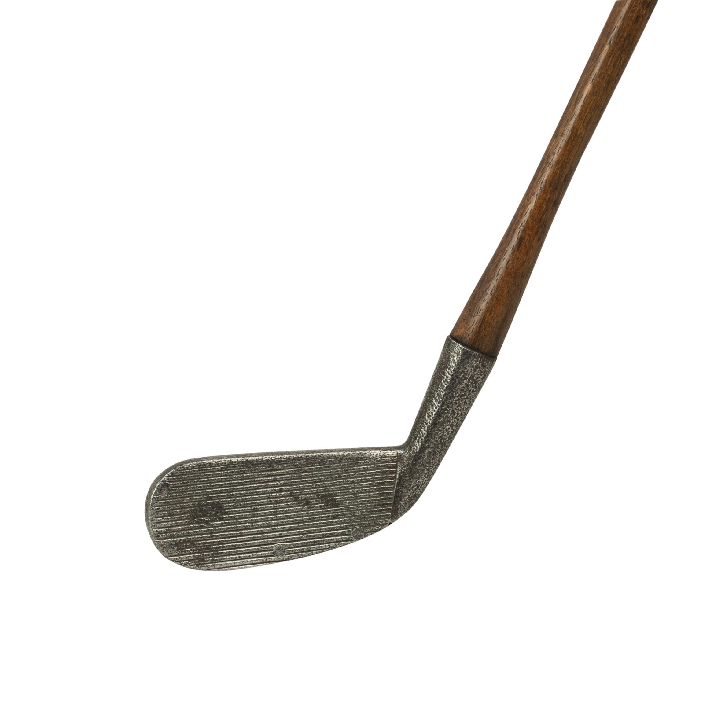 A.G. Spalding & Bros. spring faced golf club iron, cleek.
A rare spring face cleek golf club with hickory shaft with a brittle rubber grip. The club is based on the principle of the 'Cran cleek', but instead of a wood face insert Spadling uses a