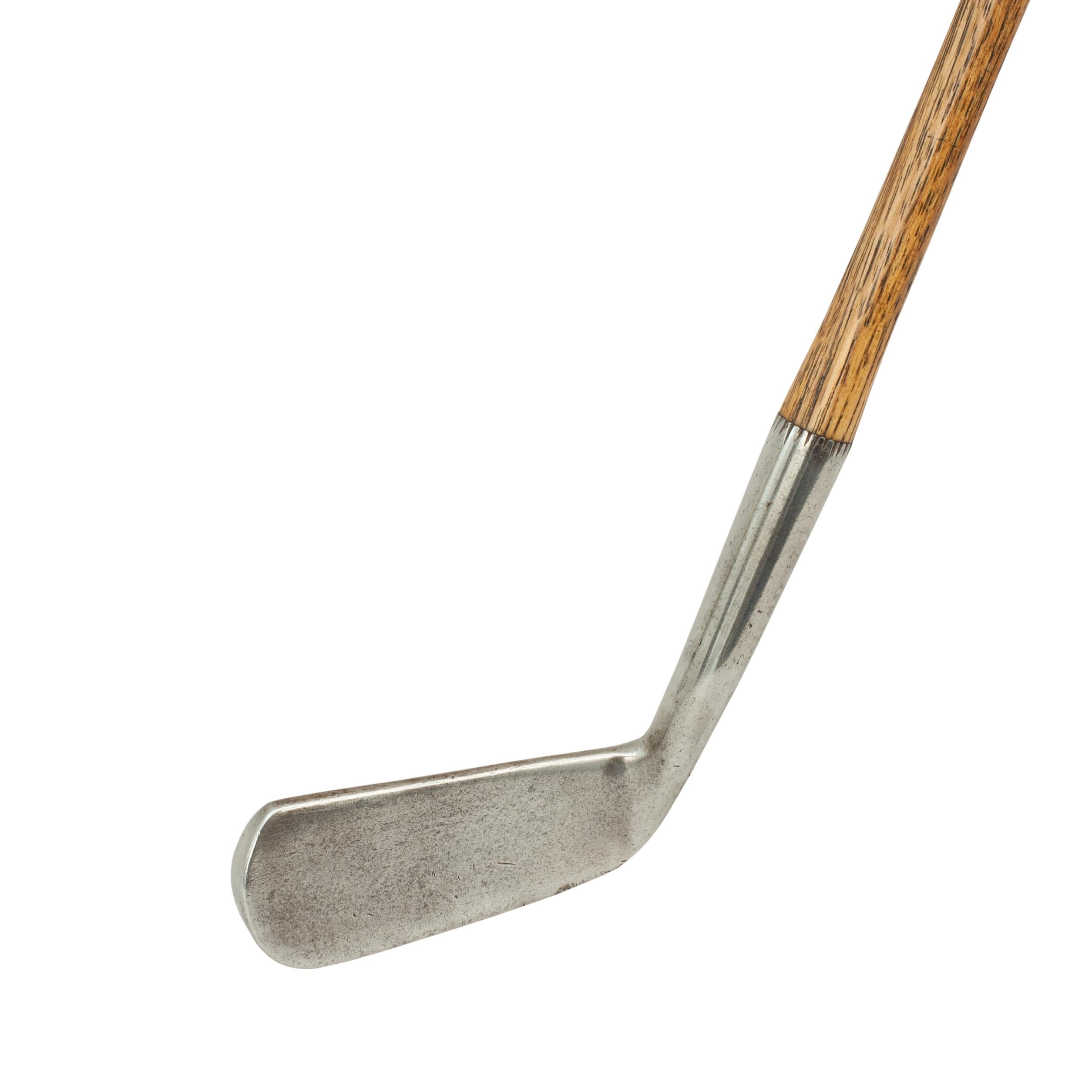 Vintage Hickory Golf Club, Wry Neck Putter, by Tom Stewart, St Andrews.
A fine and nicely weighted smooth faced offset putter by Tom Stewart of St. Andrews. Hickory shafted with polished leather grip. On the rear of the club head is the 'PIPE'