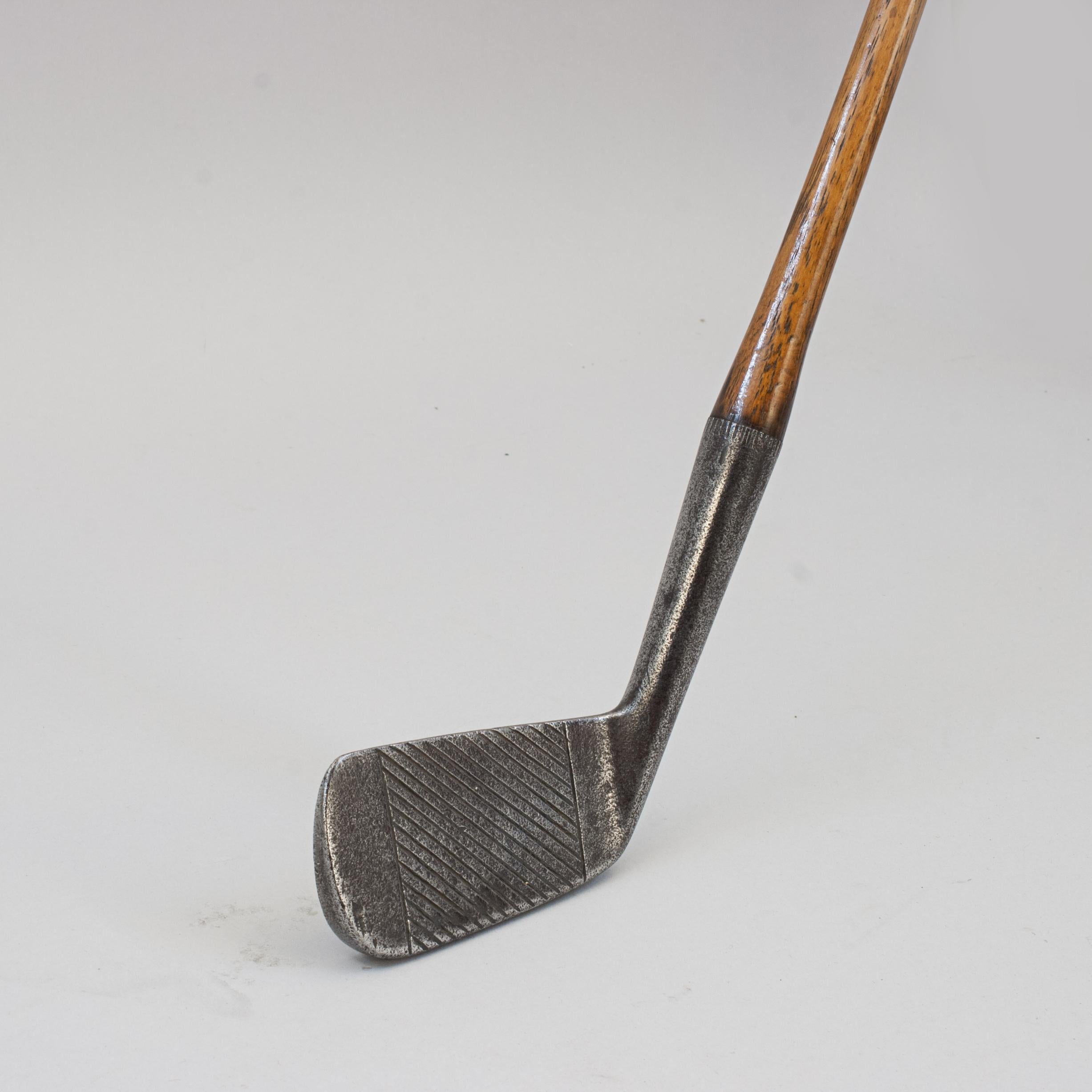 Unusual Deep Face Golf Club By Gibson Of Kinghorn.
Hickory golf club iron by William Gibson, Fife. The deep face iron with diagonal line face markings, the rear of the club head is with the 'Out Line Star' cleek mark of Gibson with the words
