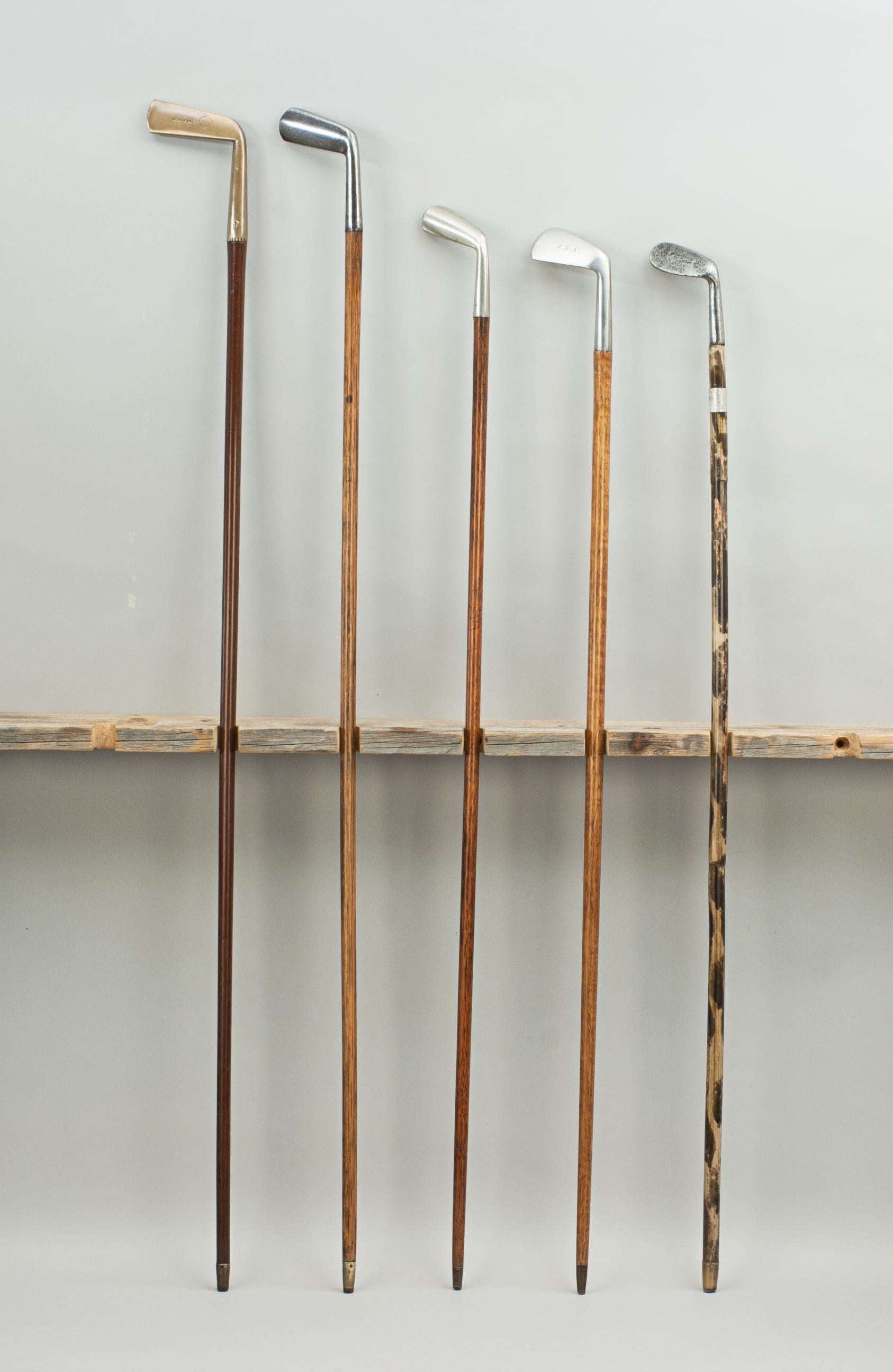 Sixteen antique golf club walking sticks, Sunday clubs.
A desirable collection of walking canes with the handles fashioned in the shape of golf club heads. Five of the walking stick heads are made of metal, the rest are made of wood and all are