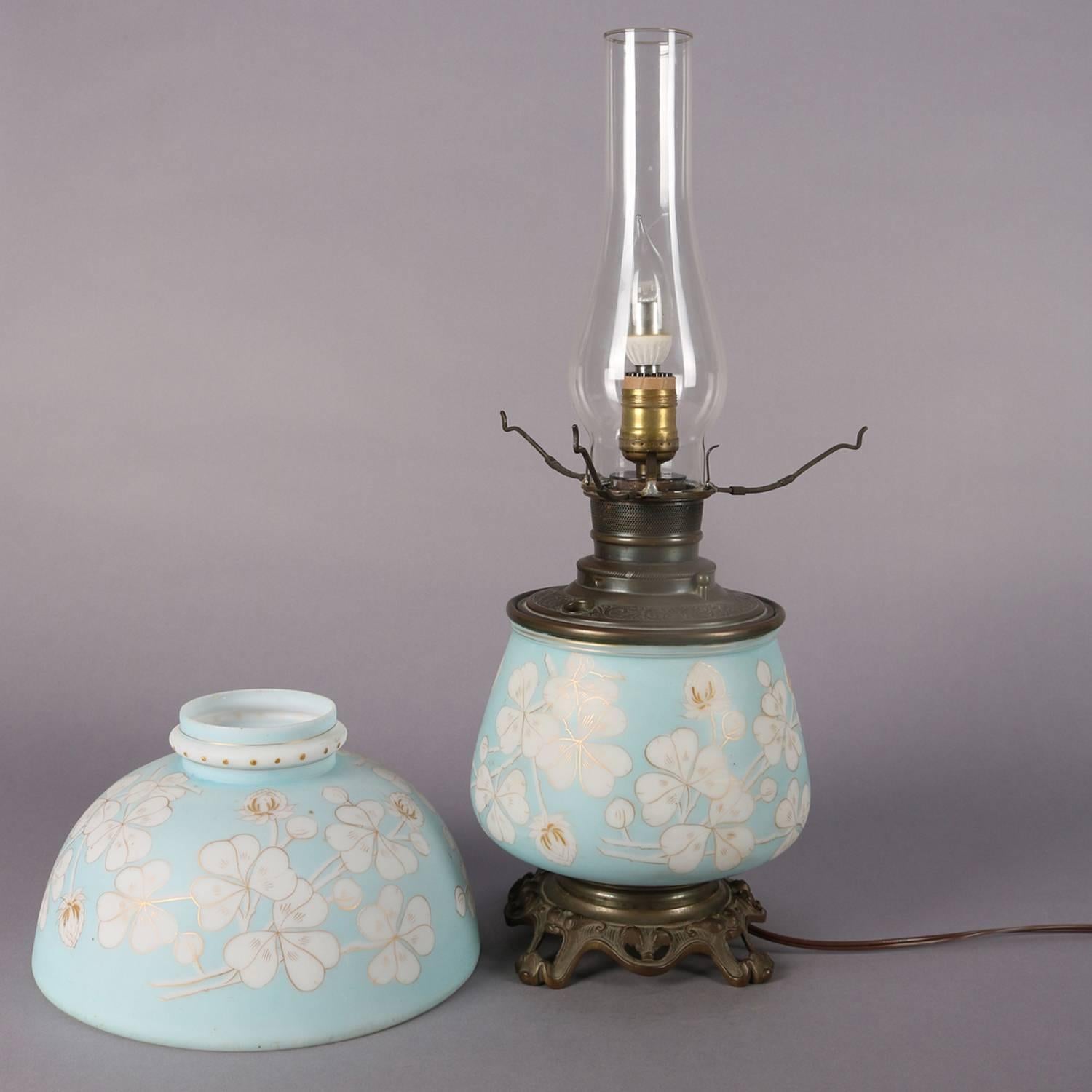 An antique Gone-with-the-Wind electrified oil lamp features blue satin glass base and shade with gilt decorated clover, circa 1890

***DELIVERY NOTICE – Due to COVID-19 we are employing NO-CONTACT PRACTICES in the transfer of purchased items. 