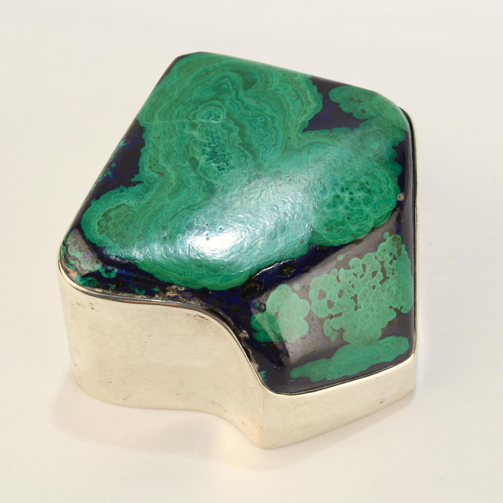 A fine Edwardian silver mounted gemstone specimen paperweight.

Made by Goodnow & Jenks for the Boston retailer Bigelow, Kennard & Co.

With a large azurite-malachite specimen polished and encased in a silver mount.

Simply an amazing paperweight