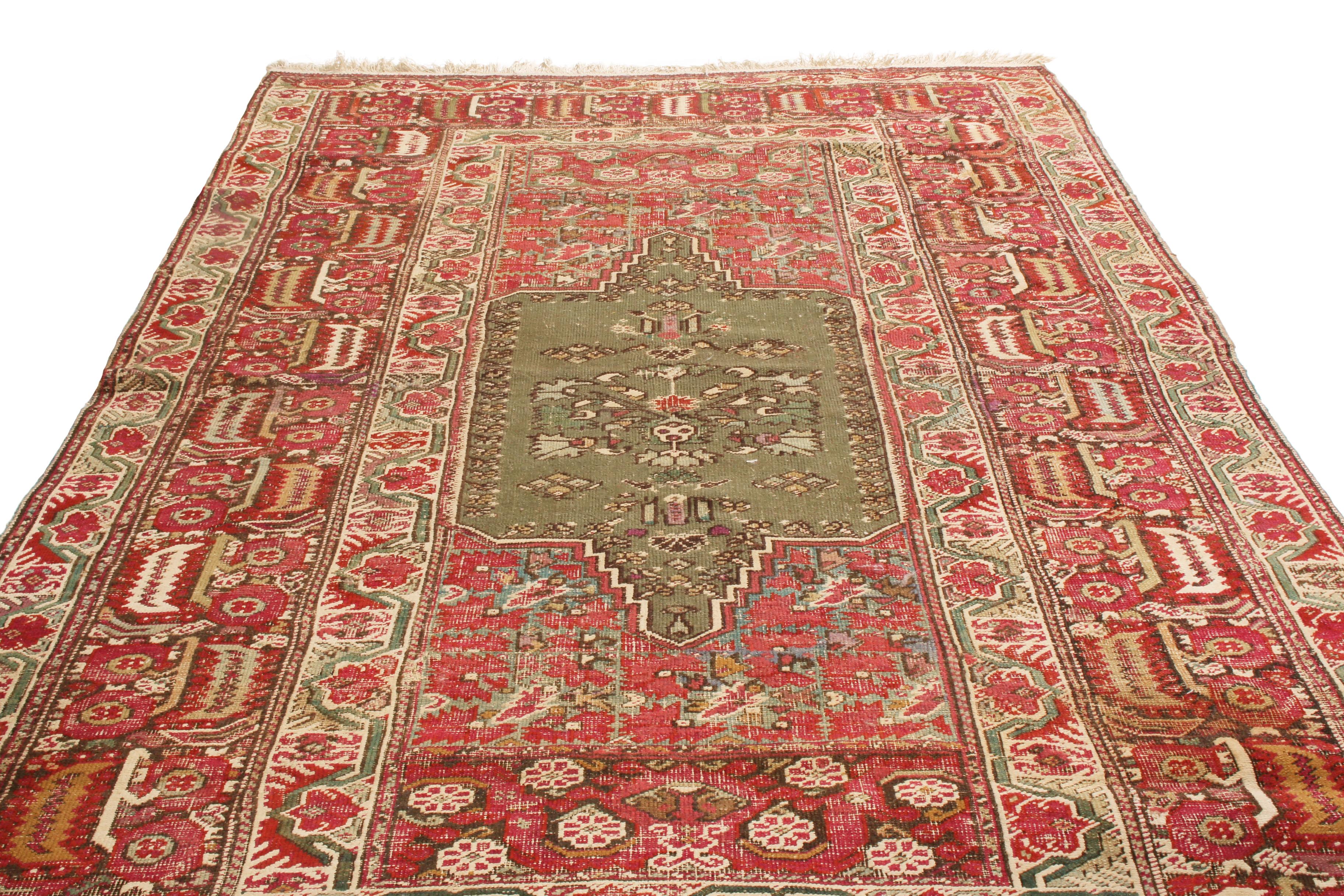 Originating from Turkey in 1890, this antique traditional Gordes wool rug features a medallion style field design and a particular finesse among its kind. Hand knotted in durable wool pile, the central sage green floral medallion resembles antique