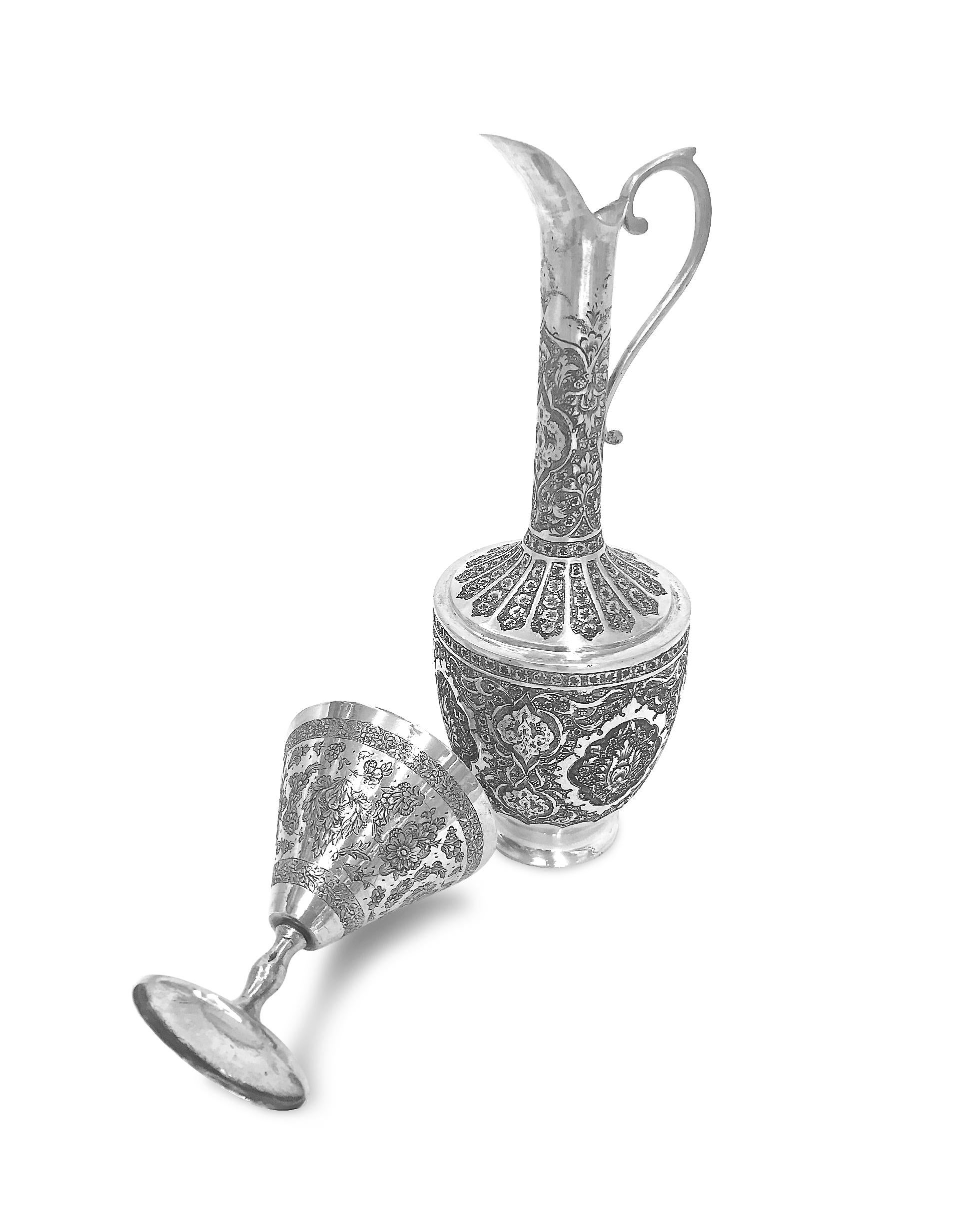 Extremely unique wine set including one pitcher, one round tray and six cups. These pieces are hand made from 0.84 karat silver  and has absolutely  gorgeous hand carved on them. The cups are unique design that  the drinking part is like a triangle