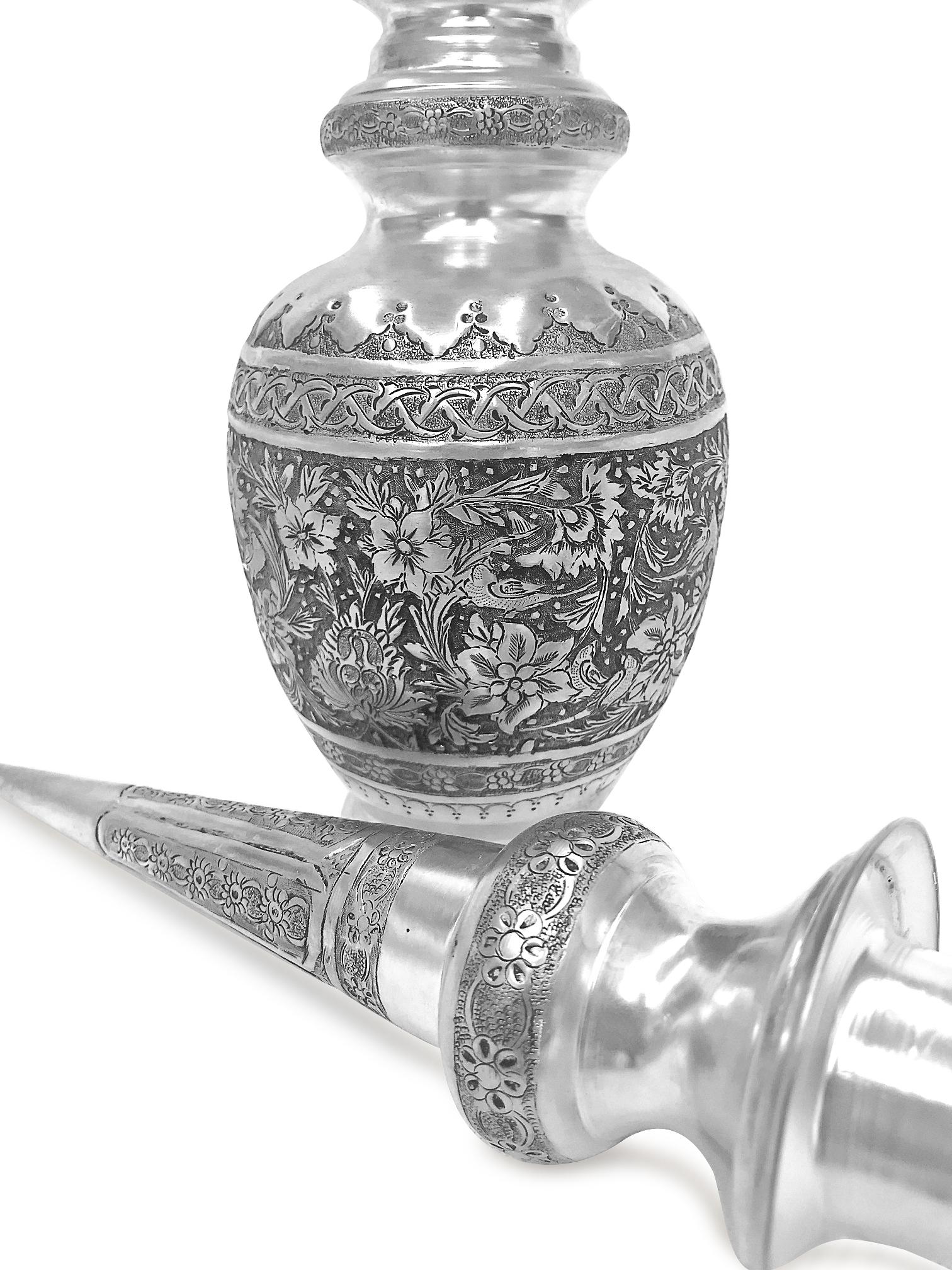 Absolutely beautiful hand made silver wine set. This pair has birds and flowers design. The wine jar set is 0.84 karat silver , could be used for wine or other drinks or just a beautiful decoration piece.
The cover of the jar has a sharp and tall