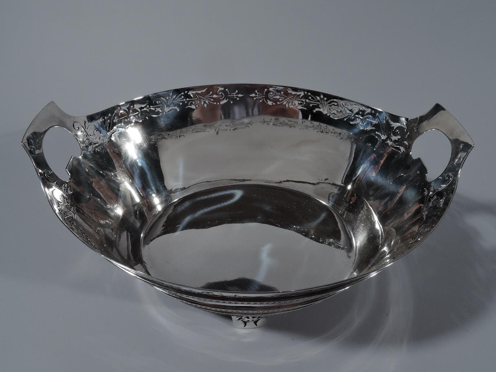 American Classical sterling silver ice bucket. Made by Gorham in Providence in 1870. Oval with straight and tapering sides. Kidney cutout bracket side handles and four straight and tapering supports. Three applied bands of stylized leaves and