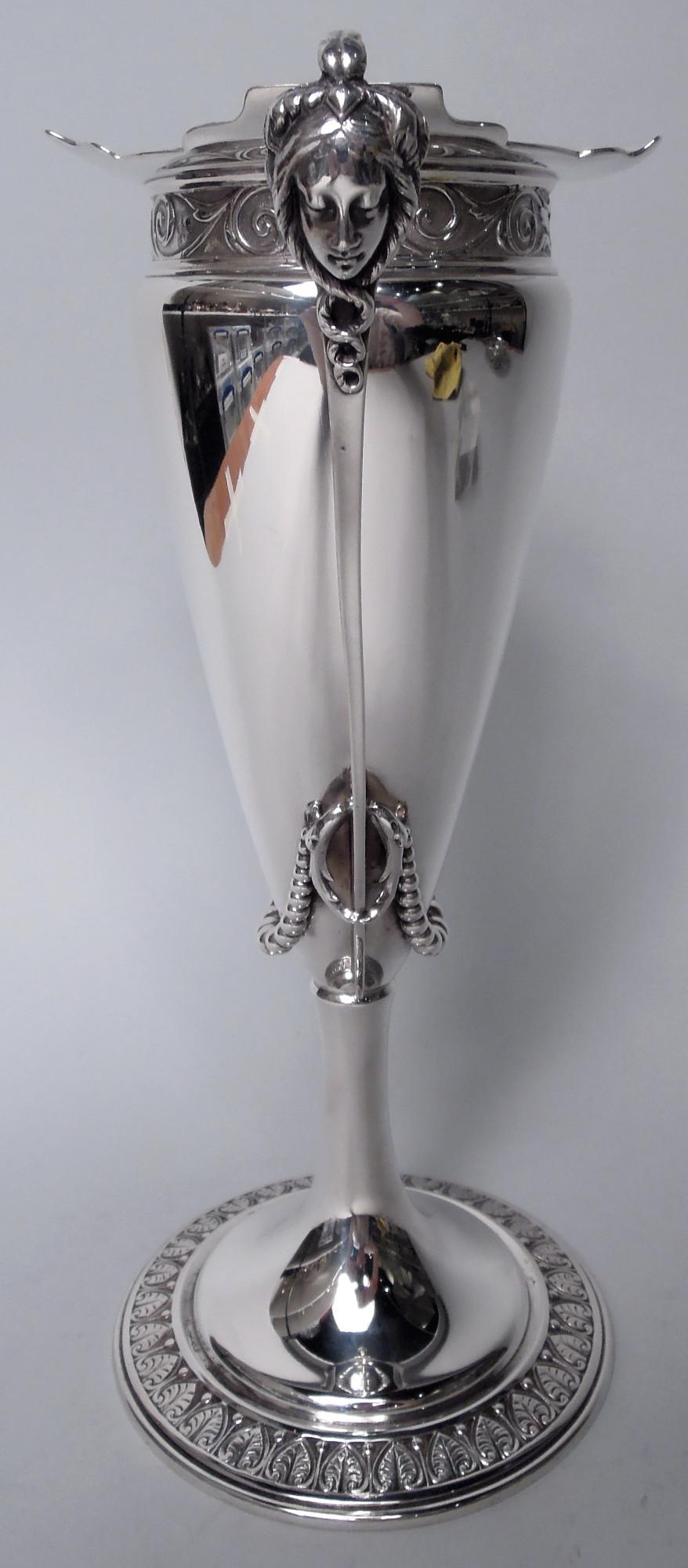 Victorian Classical coin silver vase. Made by Gorham in Providence, ca 1860. Conical bowl with everted curvilinear rim; tapering bracket side handles mounted with cast female heads and threaded with beaded swags. Cylindrical stem flowing into raised