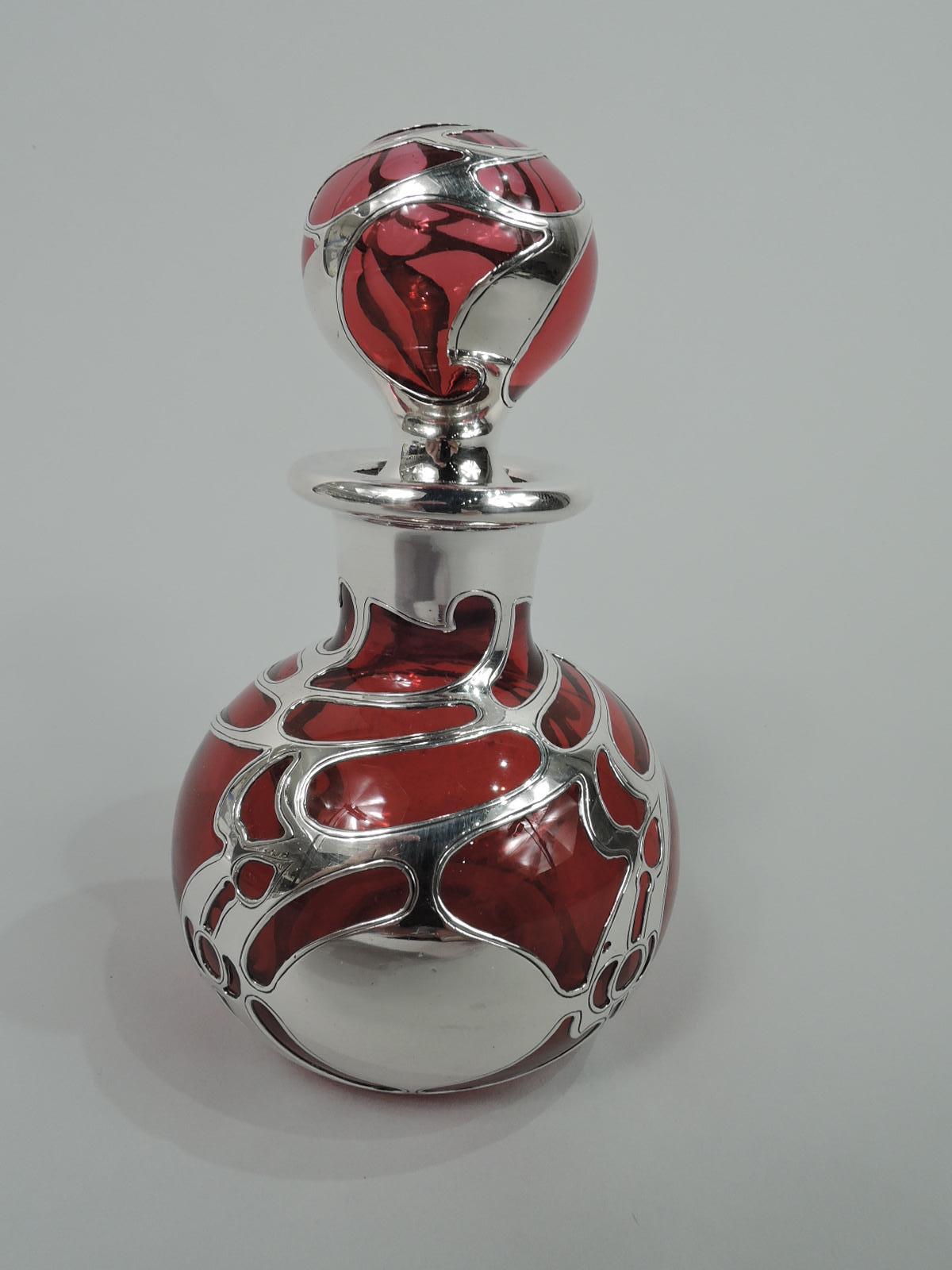Turn-of-the-century Art Nouveau glass perfume with engraved silver overlay. Made by Gorham in Providence. Globular with short neck and everted rim in silver collar. Ball stopper. Open and whiplash overlay with linear borders, and round cartouche