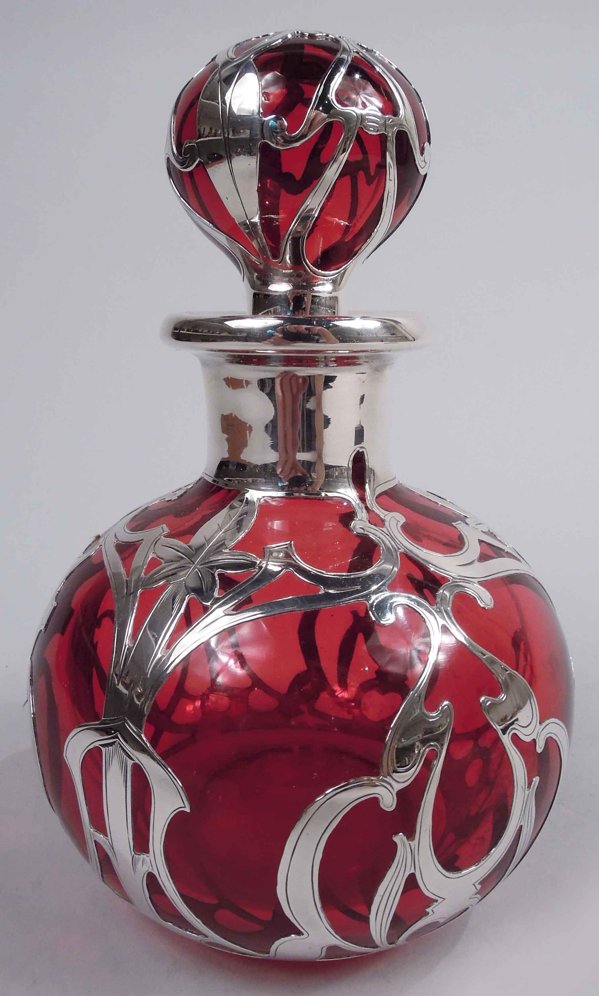 Art Nouveau glass perfume with engraved silver overlay. Made by Gorham in Providence, ca 1900. Globular with short neck and everted rim in silver collar; ball stopper. Overlay in open stylized pattern with leafing tendrils and interlaced and