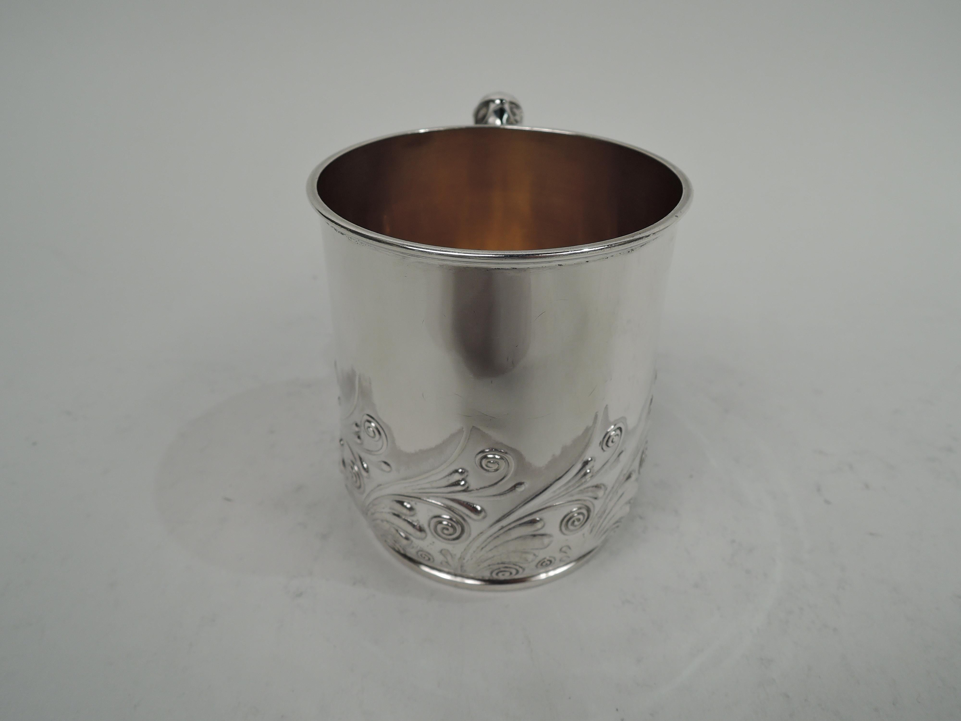 Art Nouveau sterling silver baby cup. Made by Gorham in Providence in 1893. Gently upward tapering sides and inset foot ring. C-scroll handle comprising imbricated volute scrolls. At bowl bottom chased stylized scrolling tendril border. Gilt