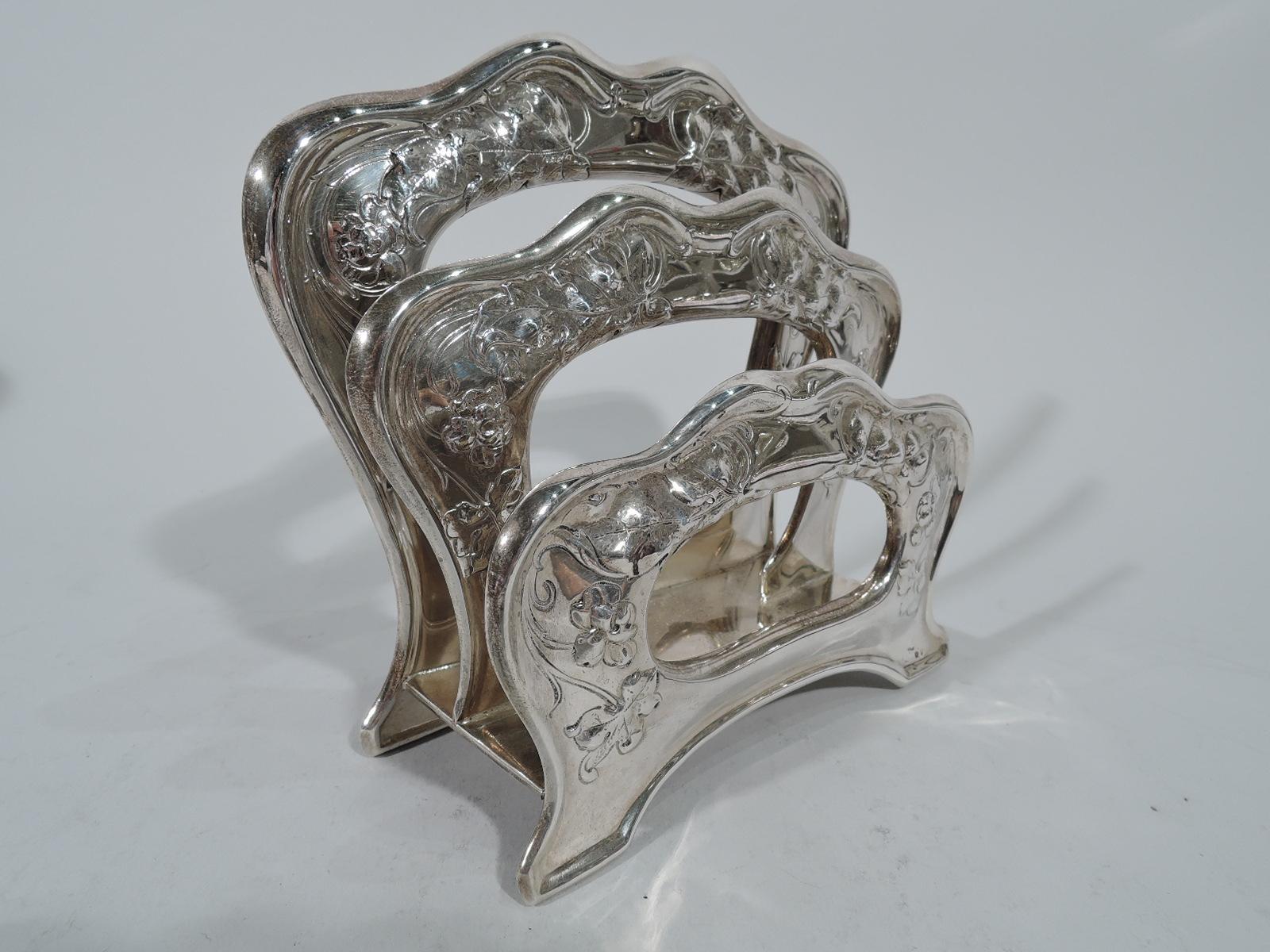 Art Nouveau sterling silver letter rack. Made by Gorham in Providence in 1901. Three shaped and open descending arches mounted to rectangular base. Front and back have bracket supports. Chased leaves and flowers. A pretty turn-of-the-century desk