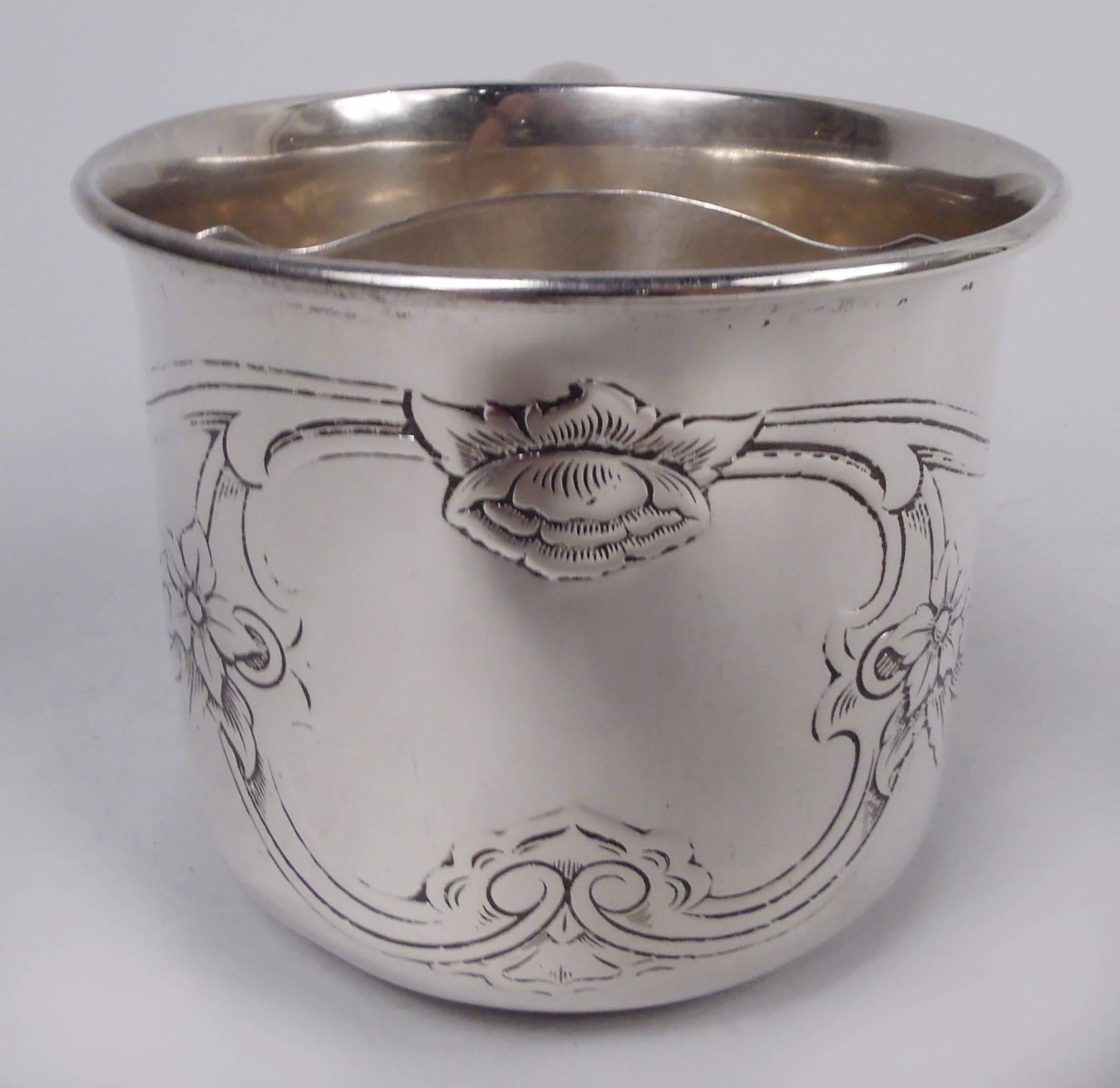 Art Nouveau sterling silver shaving mug. Made by Gorham in Providence, ca 1900. Round bowl; interior mounted with pierced brush holder. C-scroll handle. Acid-etched flowering scrollwork forming frame (vacant). Fully marked including maker’s stamp