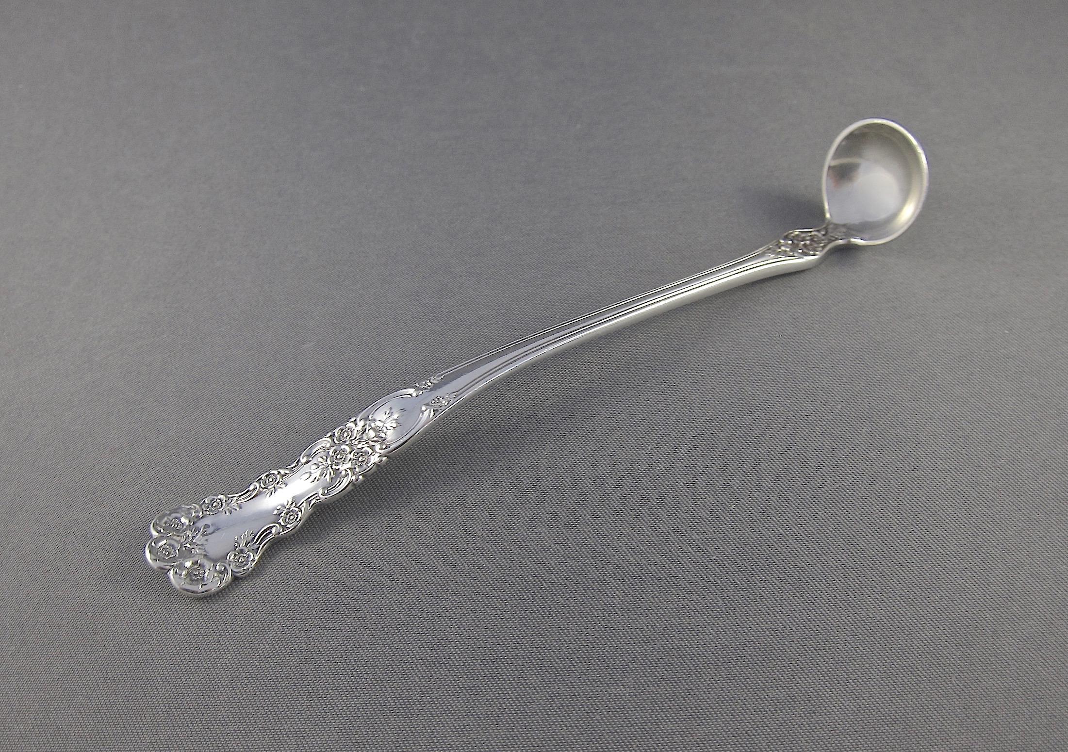 An antique sterling silver mustard spoon from the collection and estate of Peggy and David Rockefeller. The solid silver spoon was made by Gorham Manufacturing Company of Providence, Rhode Island.

The ornamental spoon is decorated with delicate