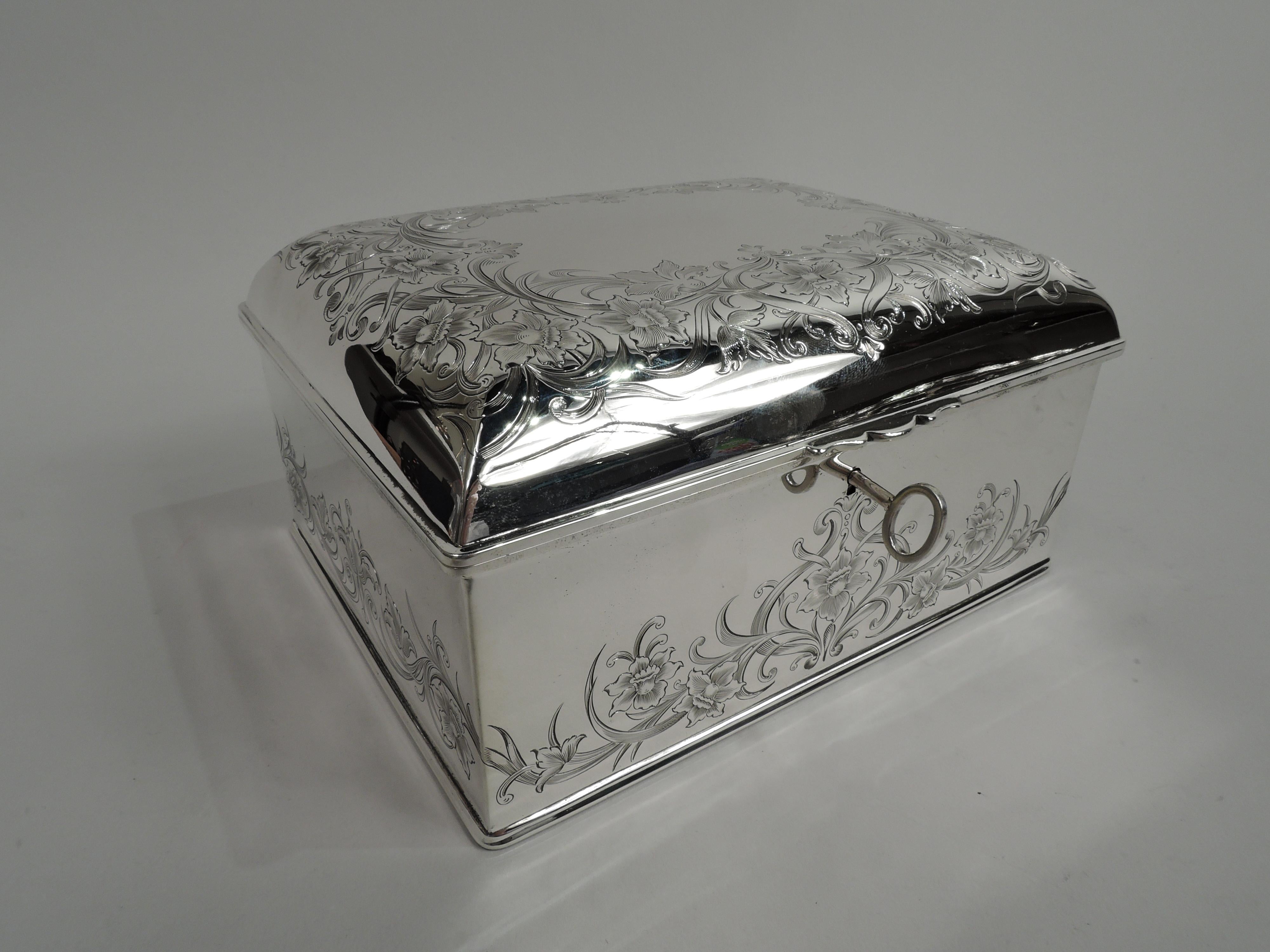 Edwardian Art Nouveau sterling silver jewelry keepsake box. Made by Gorham in Providence in 1907. Rectangular with straight sides. Cover hinged and raised with scrolled tab. Engraved ornament: Fluid and entwined leafing scrolls and flowers.