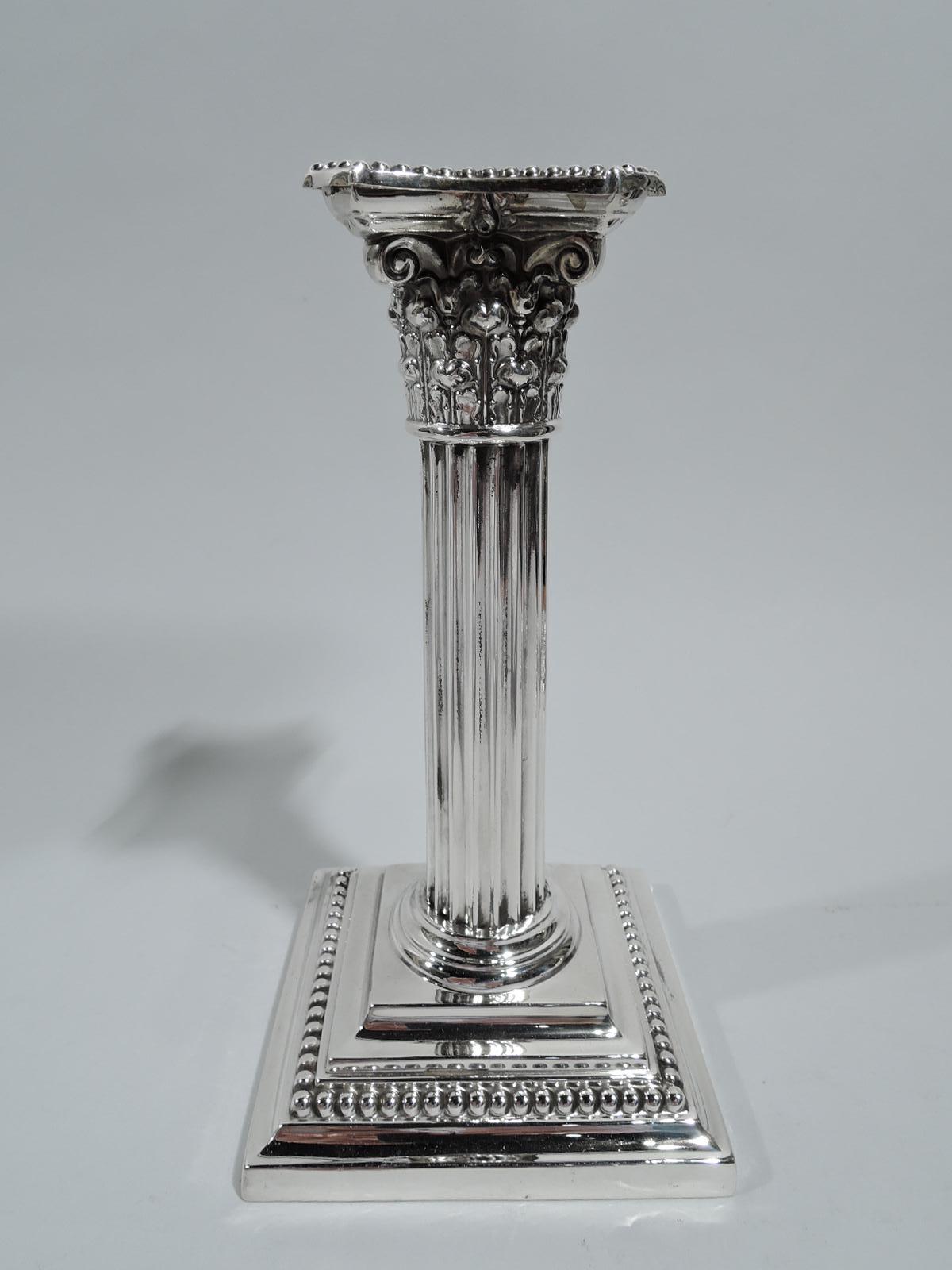 Edwardian Classical sterling silver candlesticks. Made by Gorham in Providence in 1904. Each: Fluted column with composite Corinthian capital and stepped square foot. Detachable bobeche. Beading. Fully marked including maker’s stamp, no. A3204, and
