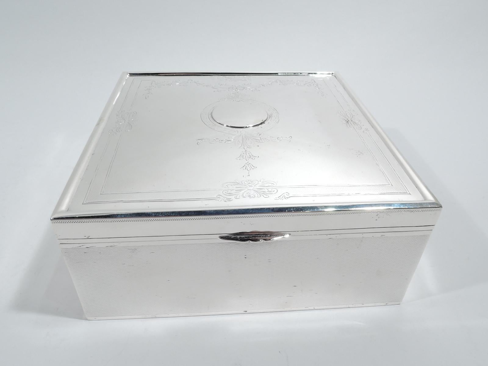 Edwardian Regency sterling silver box. Made by Gorham in Providence in 1917. Square with straight sides. Cover hinged with gently curved top and scrolled top. Allover engine-turned wave ornament on box sides and cover top, which also has engraved
