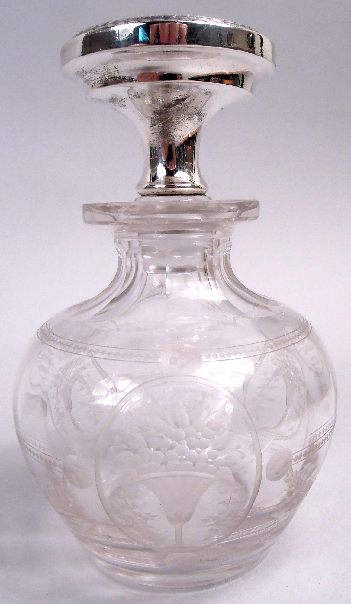 Edwardian Regency crystal perfume bottle with sterling silver and enamel stopper. Made by Gorham in Providence, ca 1910. Globular bowl with faceted shoulder and neck, and everted rim. Acid-etched flower baskets and garlands; beaded and paterae