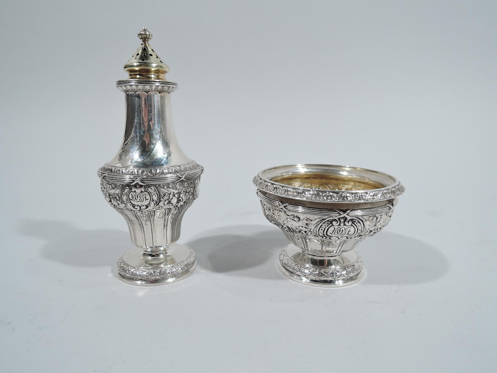 Turn-of-the-century sterling silver open salt and pepper shaker. Made by Gorham in Providence. Salt: Round and tapering bowl with turned-down rim and raised foot. Pepper: Baluster with pierced conical top and raised foot. Neck has subtle twisted