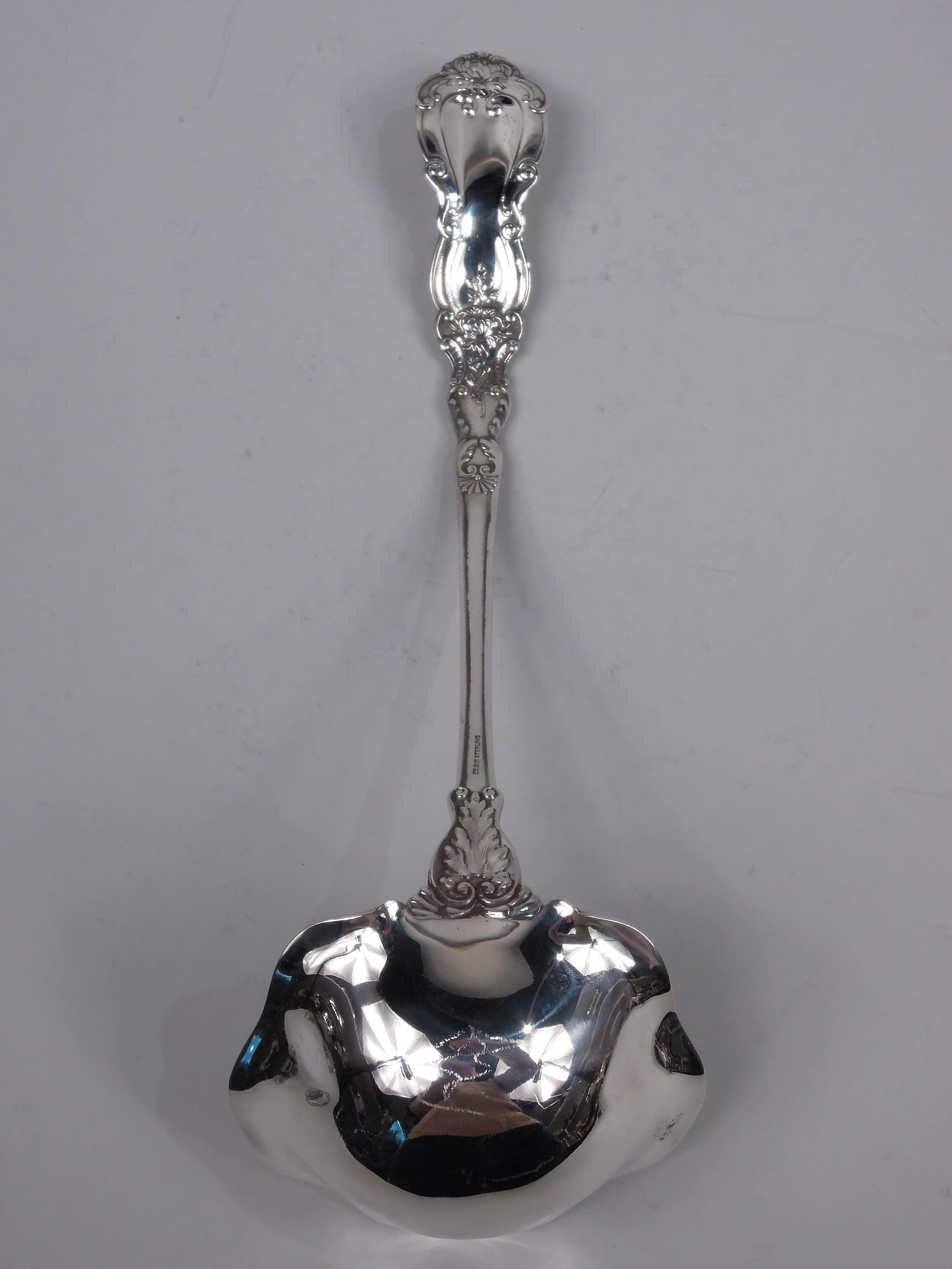 Imperial Chrysanthemum sterling silver soup ladle. Made by Gorham in Providence, ca 1900. Tapering stem with waisted terminal and lobed round bowl. Dense ornament with flowers and leaves. Bowl interior gilt-washed with same. A nice serving piece in