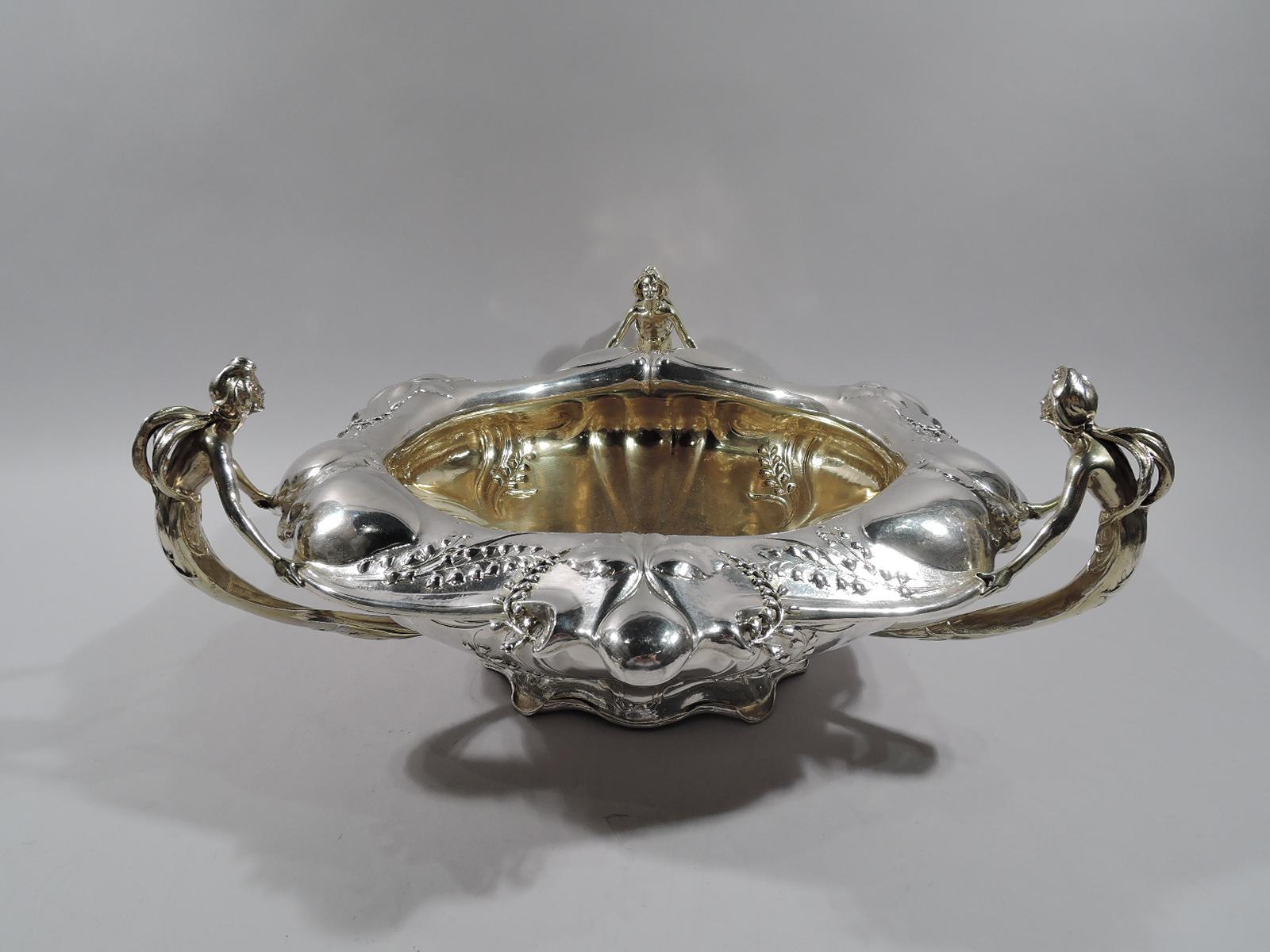 Art Nouveau Martelé silver centerpiece. Made by Gorham in Providence, circa 1920. Bellied on raised and scrolled and curling foot. Rim wide and turned down with chased vegetation with serrated leaves, and chased and applied flowers (lily of the