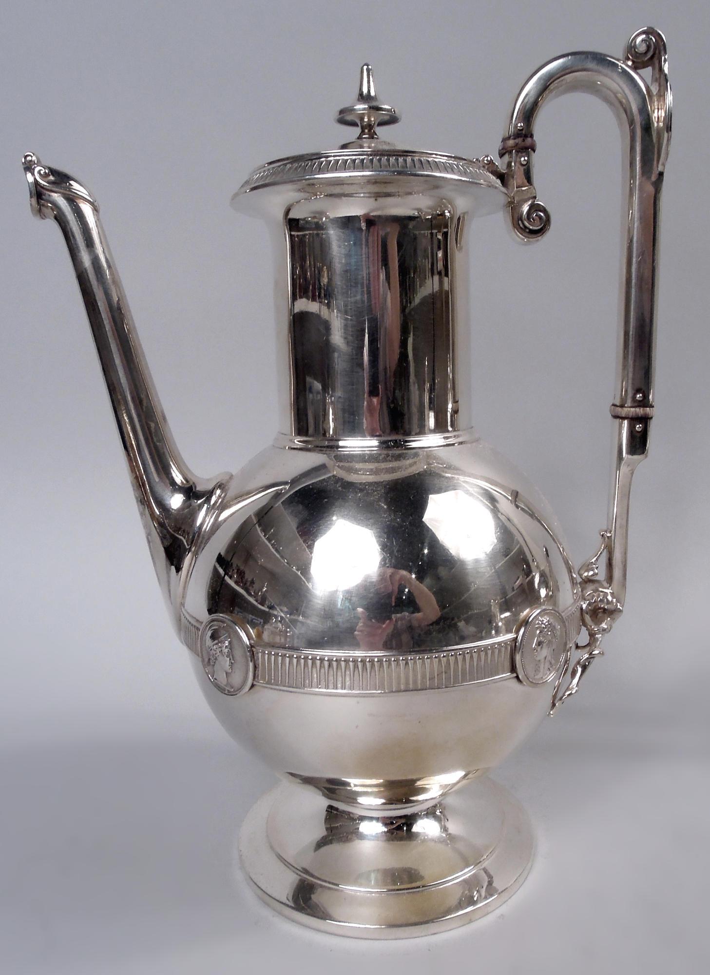 Medallion coin silver coffee and tea set. Made by Gorham in Providence, ca 1860. This set comprises 5 pieces: coffeepot, teapot, creamer, sugar, and waste bowl. Globular bowls on stepped feet. Necks cylindrical and covers hinged with vasiform