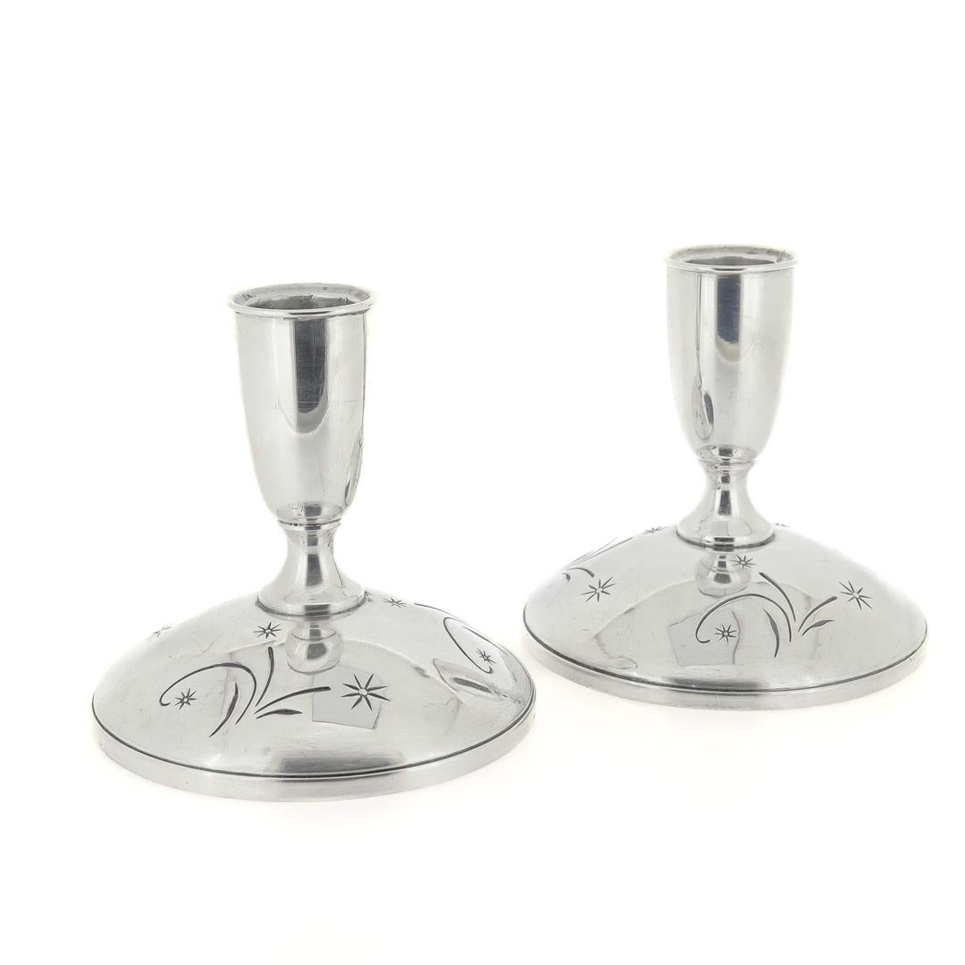 A fine pair of Mid-Century Modern candlesticks.

In sterling silver.

By Gorham.

In the Celeste pattern.

Each marked to the base with Gorham / Sterling / Cement Filled / Reinforced With Rod of Other Metal / 1335

Simply a wonderful pair of