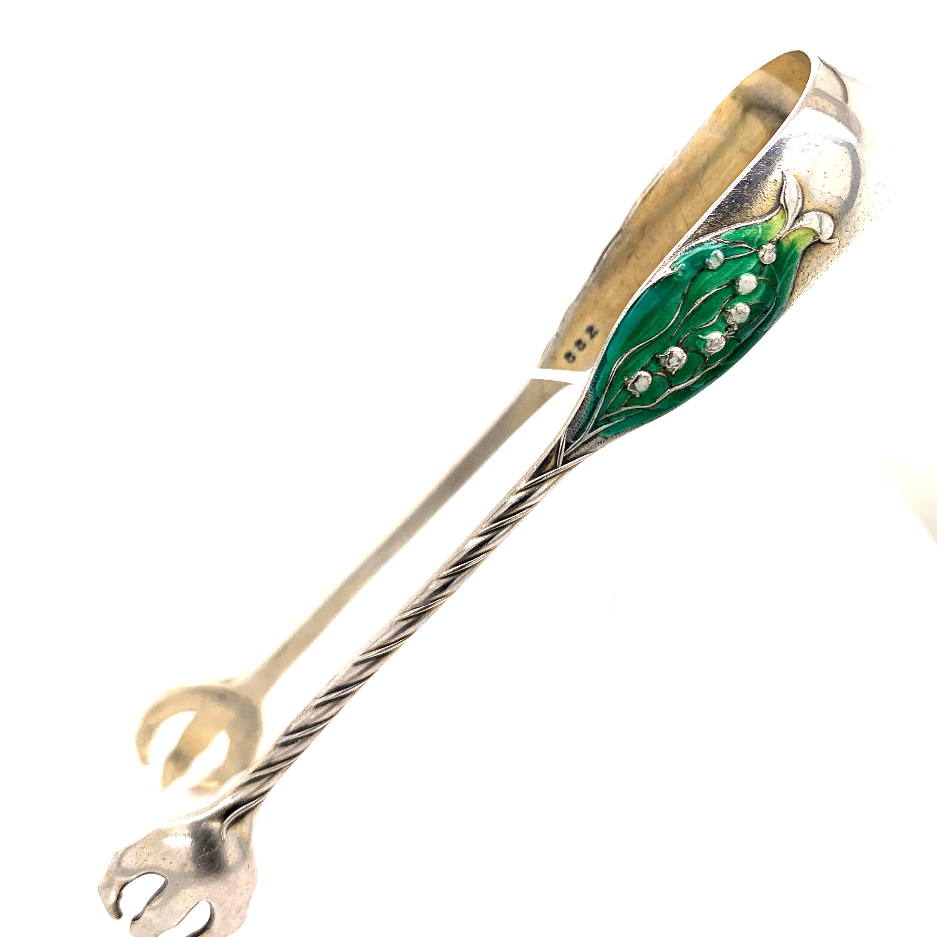 Beautiful antique sterling silver sugar tongs.  Made by GORHAM.  On the front, an enamel 