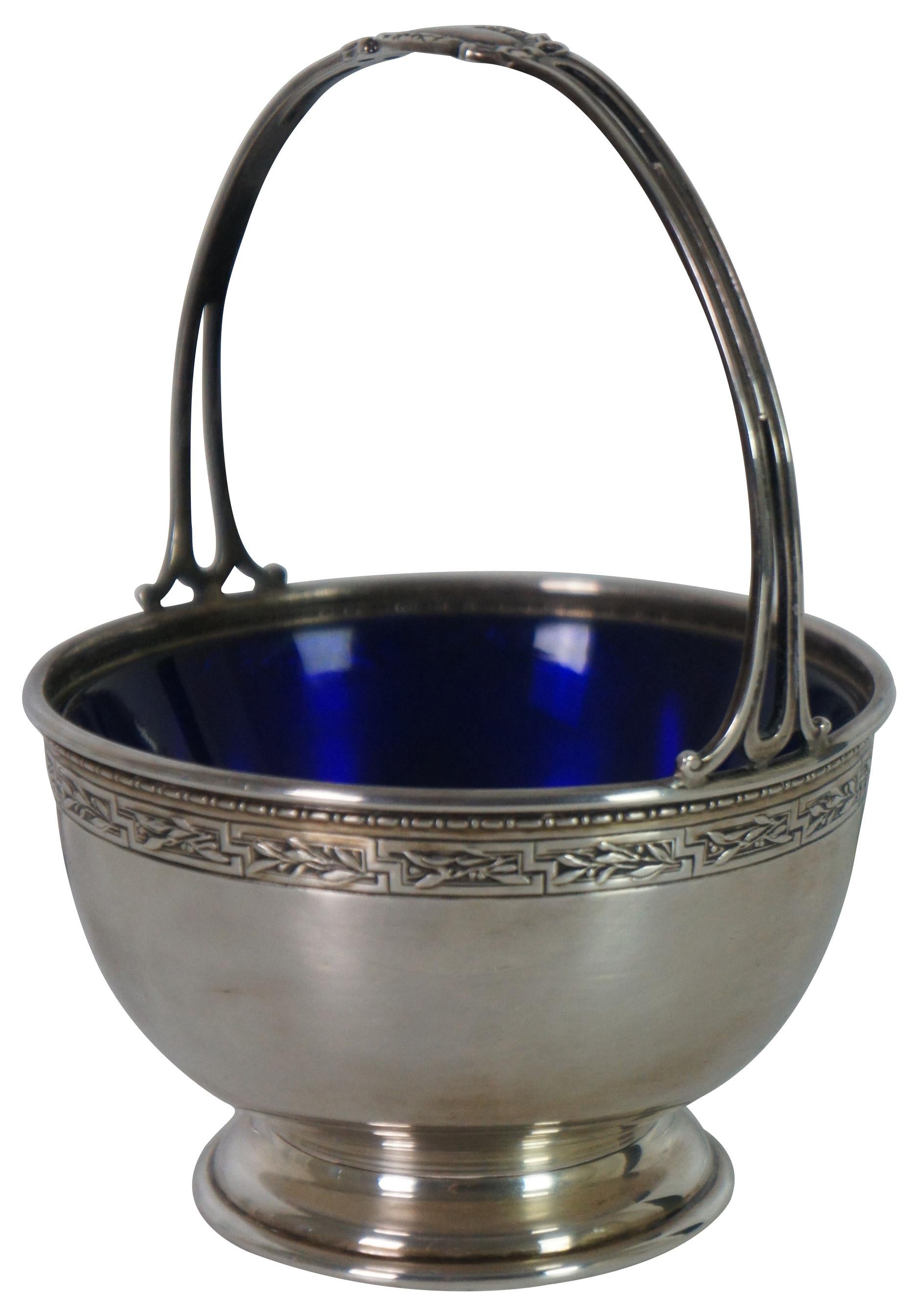 Antique Gorham sterling silver, number 103, pedestal basket with handle and cobalt blue sugar dish / bowl insert.

Measures: 4.5” x 4.125” x 5.75” / 133.9 g (Width x Depth x Height).