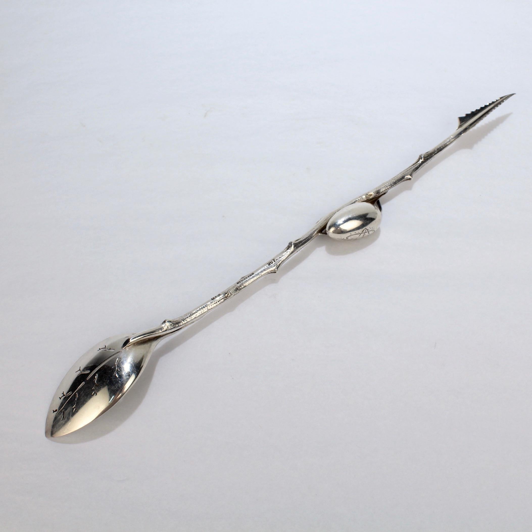 A finely cast Gorham sterling silver olive spear.

Fashioned as dual-use olive spear and olive spoon. It has a 3-dimensional olive and 2 leaves applied at the center of a twig handle and leaf engravings to the pierced bowl.

This variant is one of