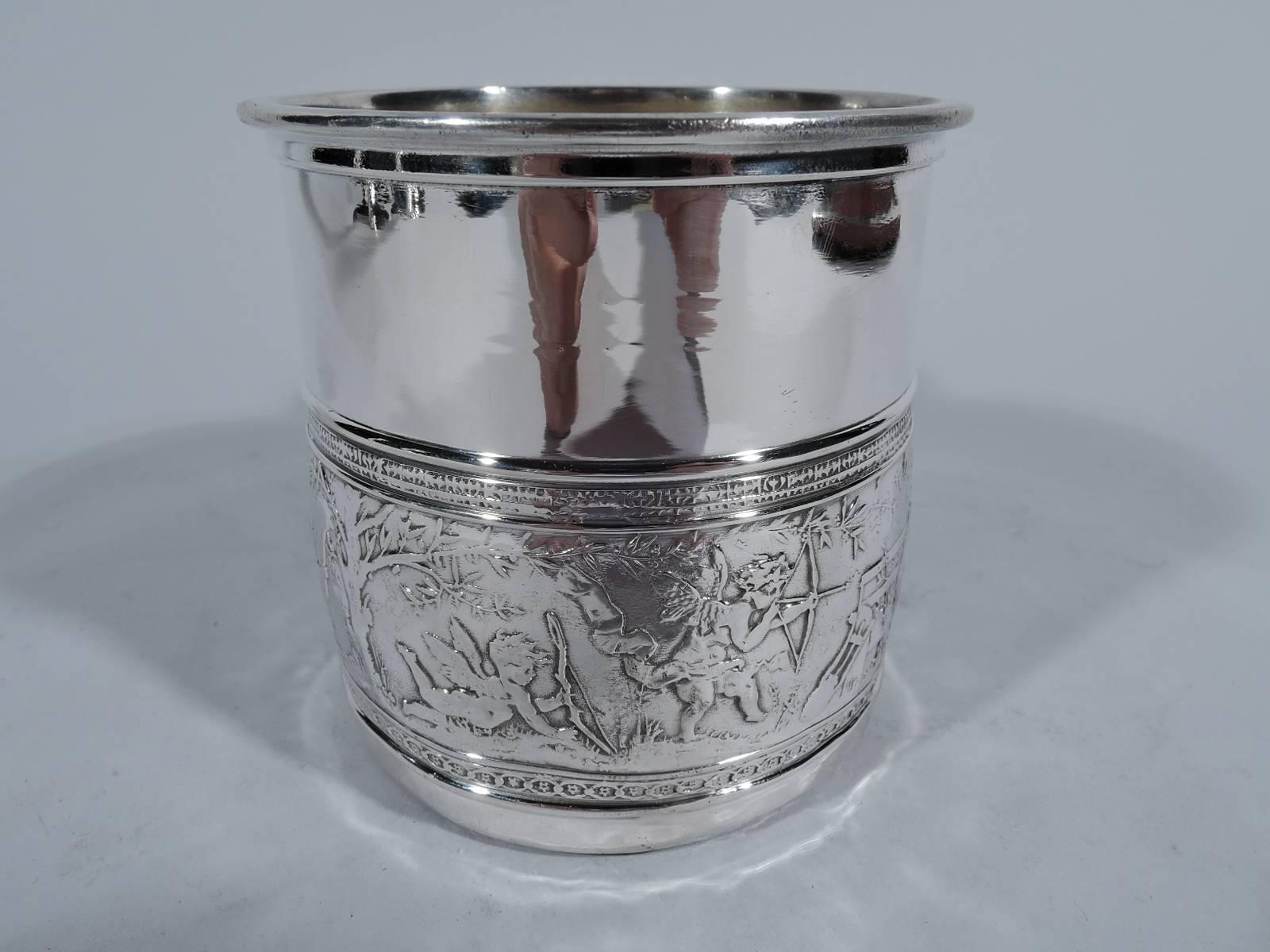 Sterling silver baby cup. Made by Gorham in Providence, circa 1900. Drum-form with scroll handle. Chased Classical frieze on bottom: A courting couple hold hands while the man holds out a flower. Two cupid archers stand ready with strung arrows. A